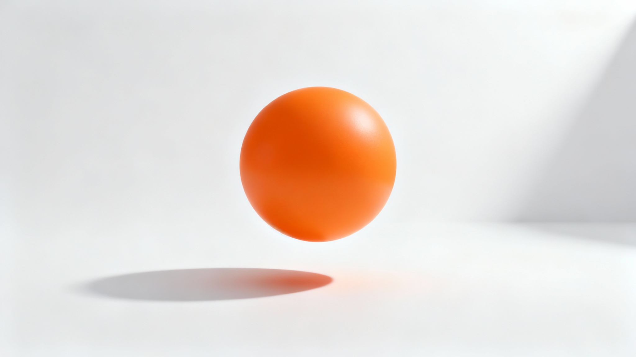 A photorealistic image of an orange sphere floating above a white surface, casting a soft and realistic shadow to demonstrate a shadow generator.