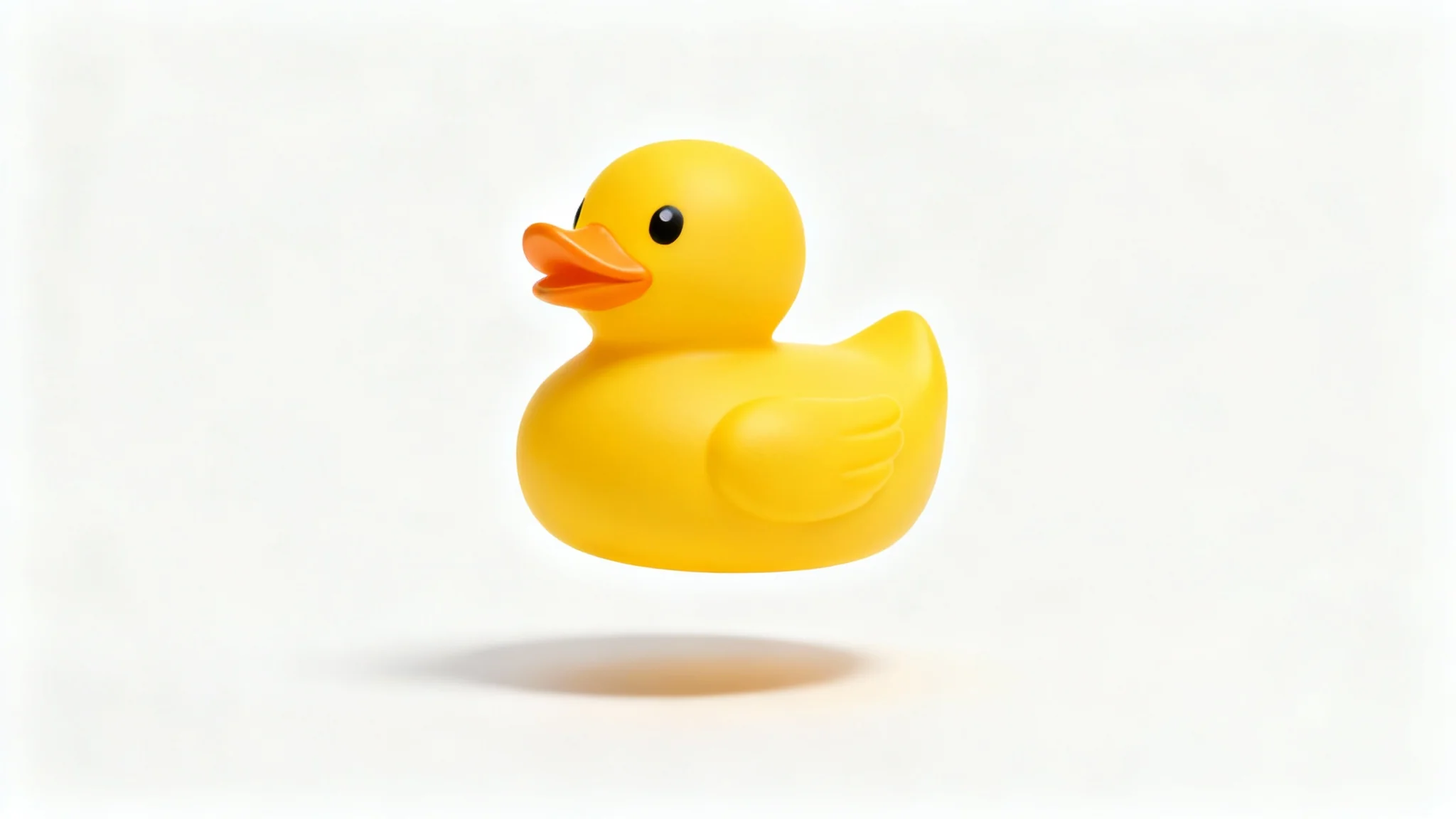 A photorealistic image of a yellow rubber duck floating over a white background, casting a soft, realistic shadow beneath it.