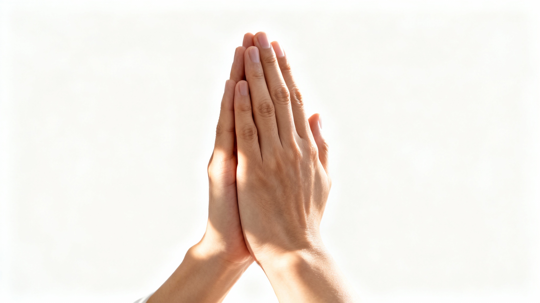 A close-up, photorealistic image of two hands clasped together in prayer, set against a sterile white background with soft, warm lighting.
