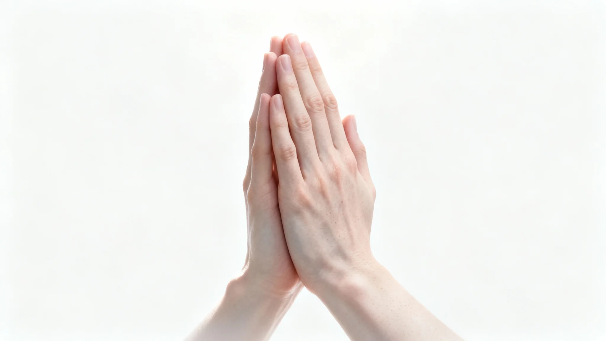 A hyper-realistic close-up photograph of a pair of hands clasped together in prayer, isolated against a pure white background, conveying a sense of peace.