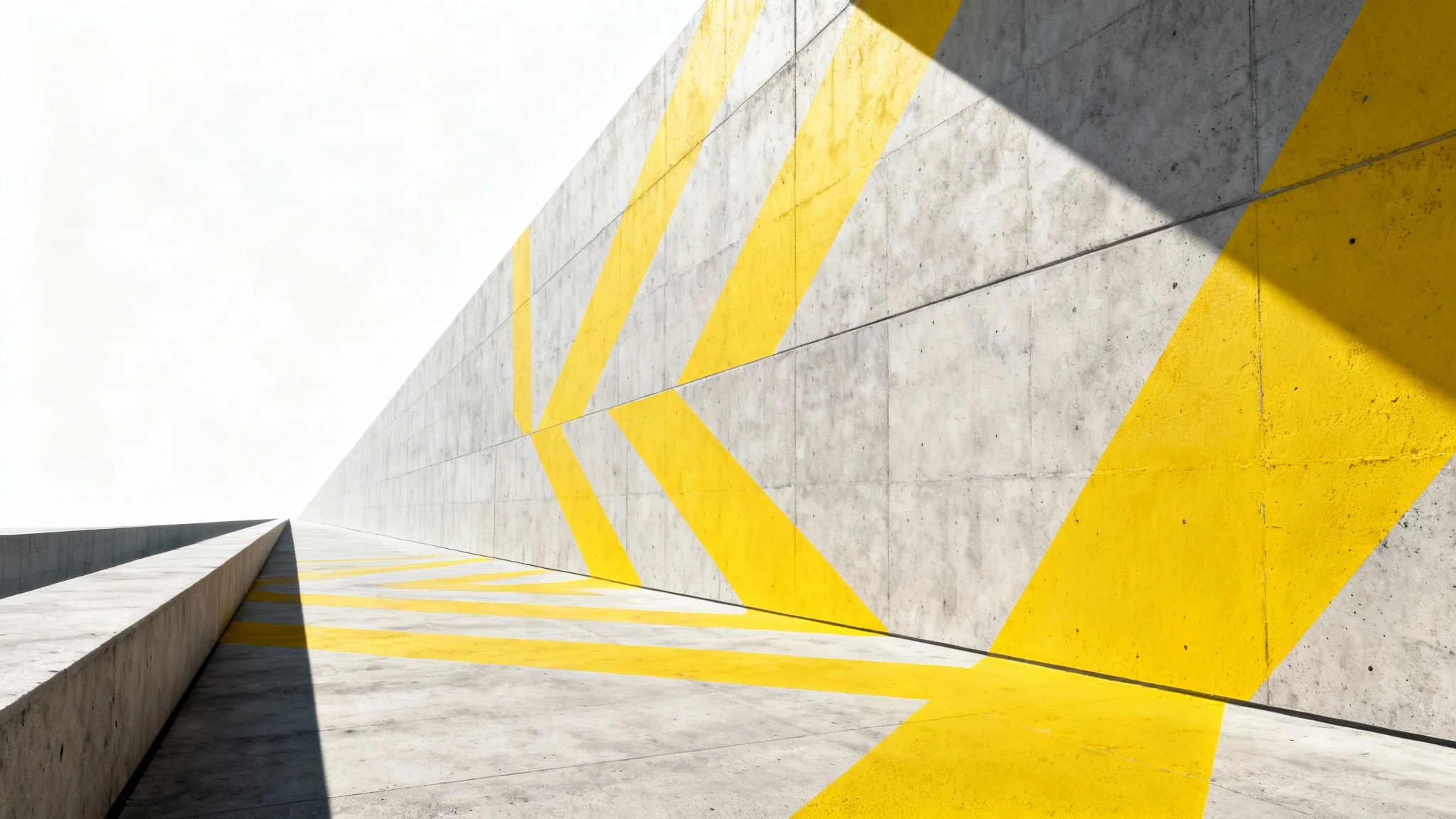 A low-angle photograph of a modern concrete wall with a bright yellow geometric pattern perfectly applied to its surface, demonstrating the concept of matching perspective against a stark white background.