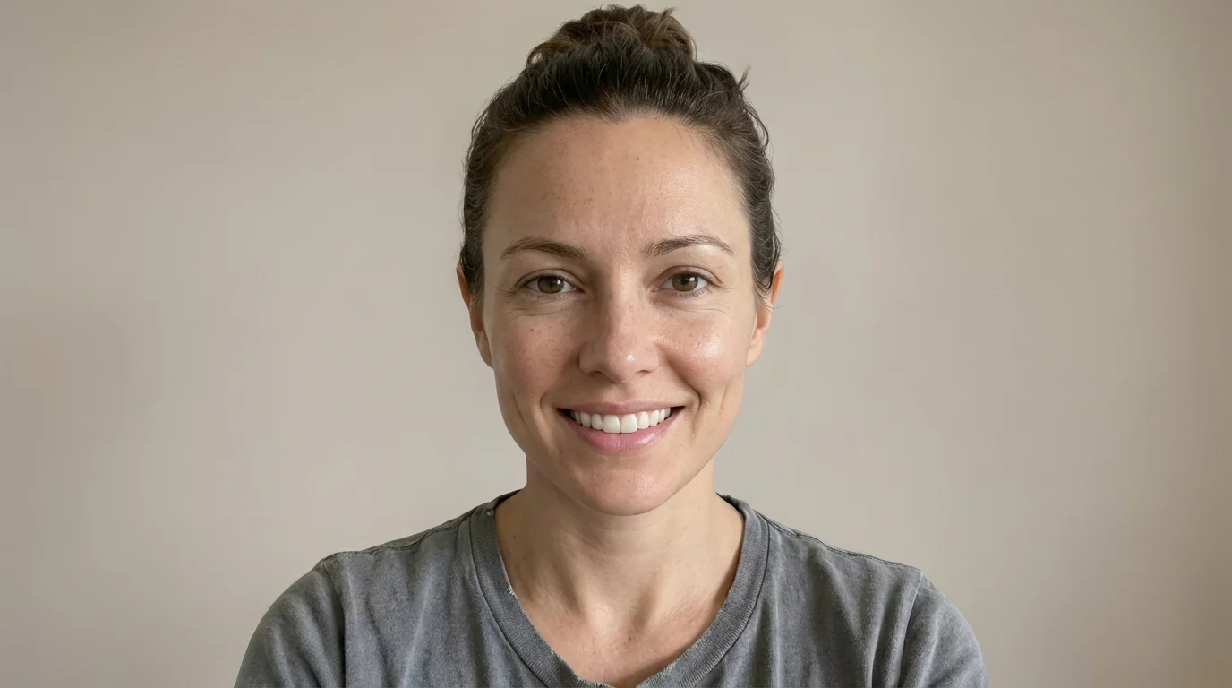 A close-up portrait of a woman smiling, her face appearing elegantly slim and contoured as the result of a digital enhancement tool.