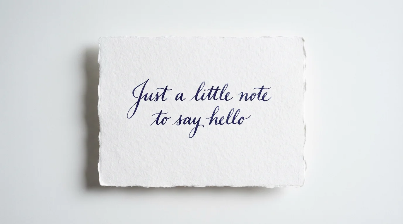 A mockup showing a piece of paper on a white background with the text 'Just a little note to say hello' written in an elegant, realistic handwriting effect.