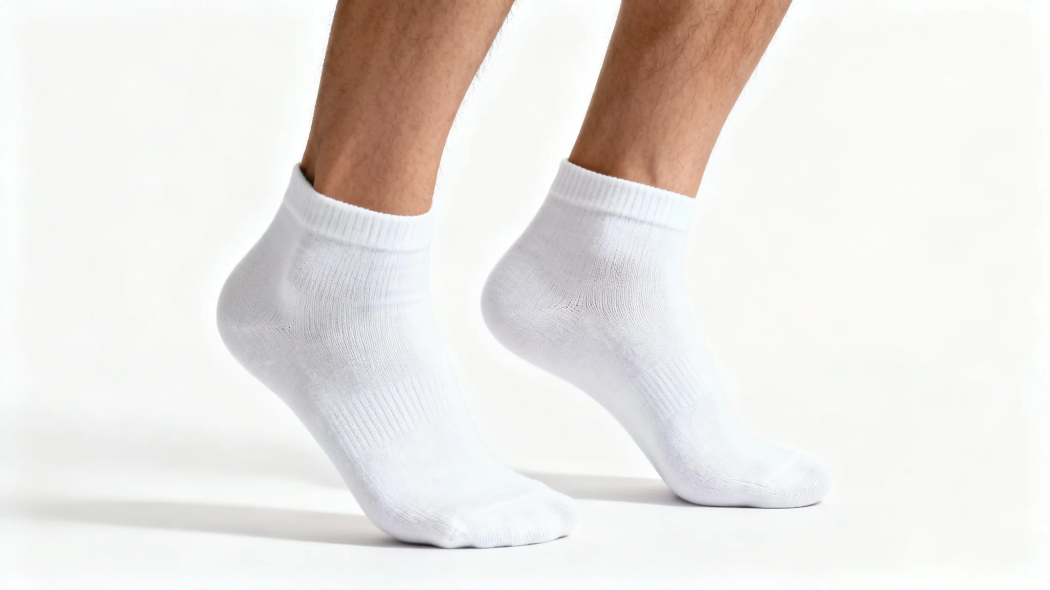 A photorealistic mockup of a person wearing clean, white ankle socks, showcased against a seamless white studio background to highlight the product's texture and fit.