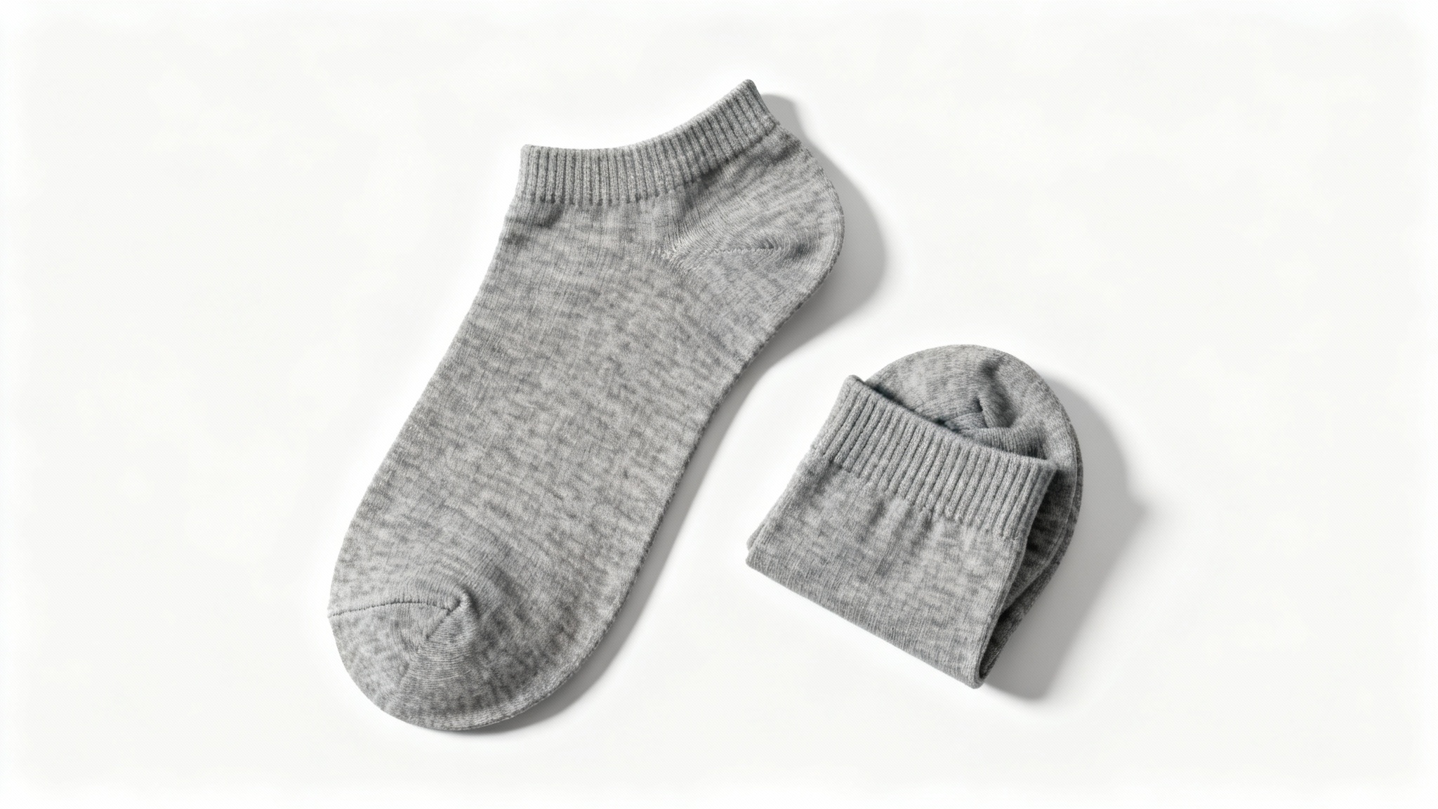 A photorealistic mockup of a pair of heather gray ankle socks, arranged neatly in a flat lay on a clean white background.