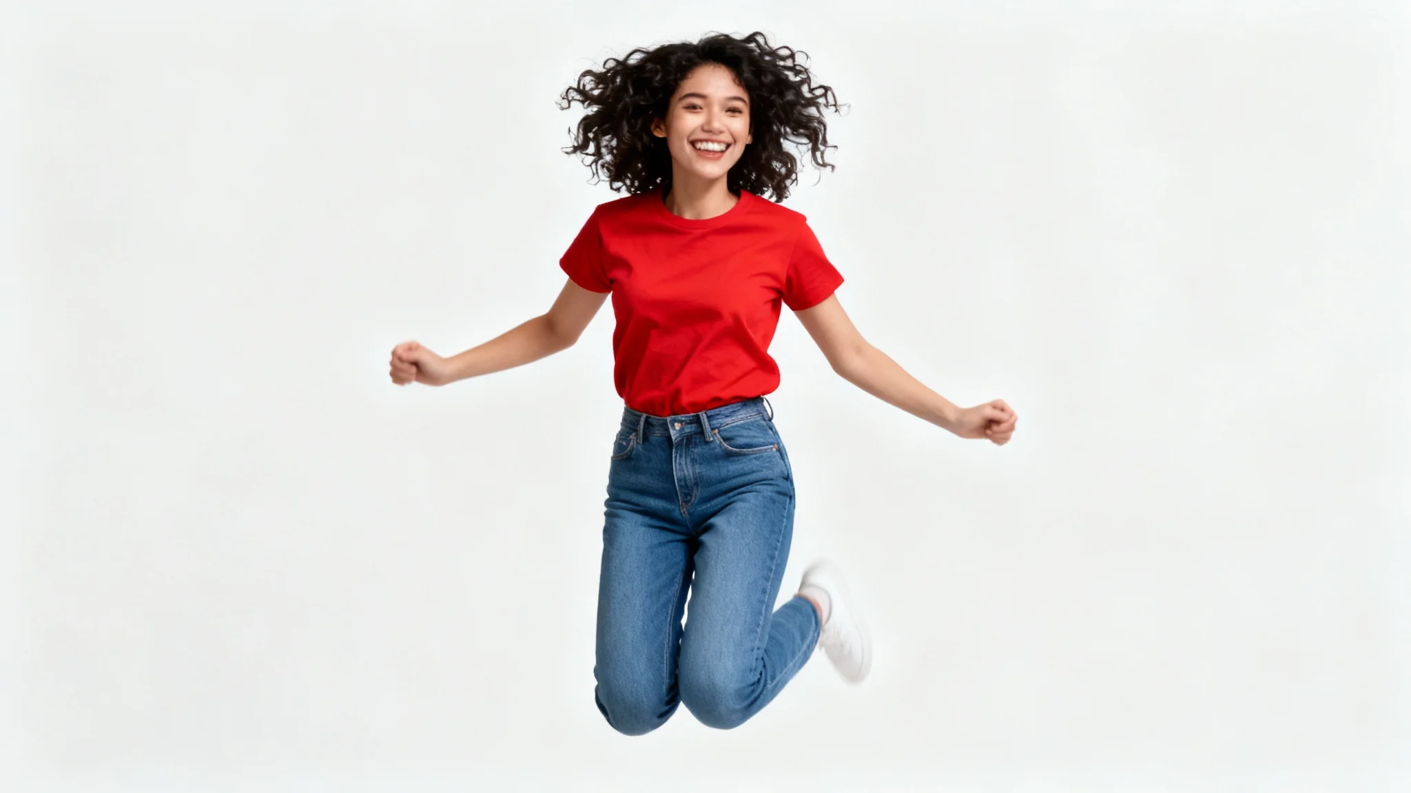 A photorealistic image of a woman with curly hair joyfully jumping in the air. She is wearing a red t-shirt and jeans against a solid white background, making her look like a perfect cutout.