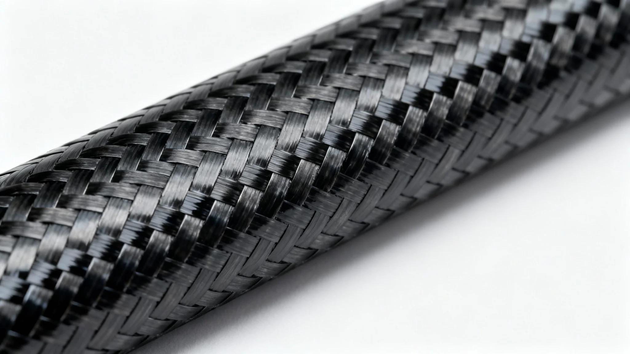 A detailed macro shot of a black carbon fiber texture with a glossy finish, showcasing its intricate woven pattern against a clean white background.