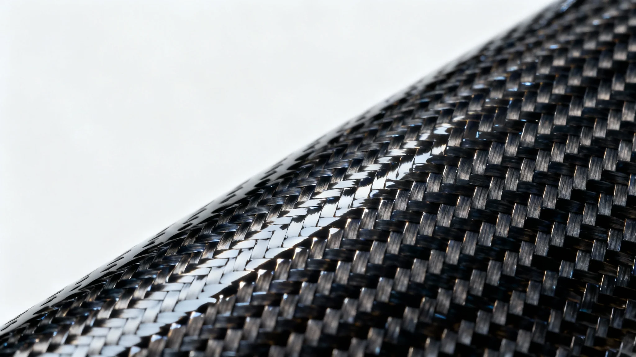 A detailed, close-up photograph of a glossy carbon fiber texture, showing the intricate twill weave pattern under dramatic lighting against a clean white background.