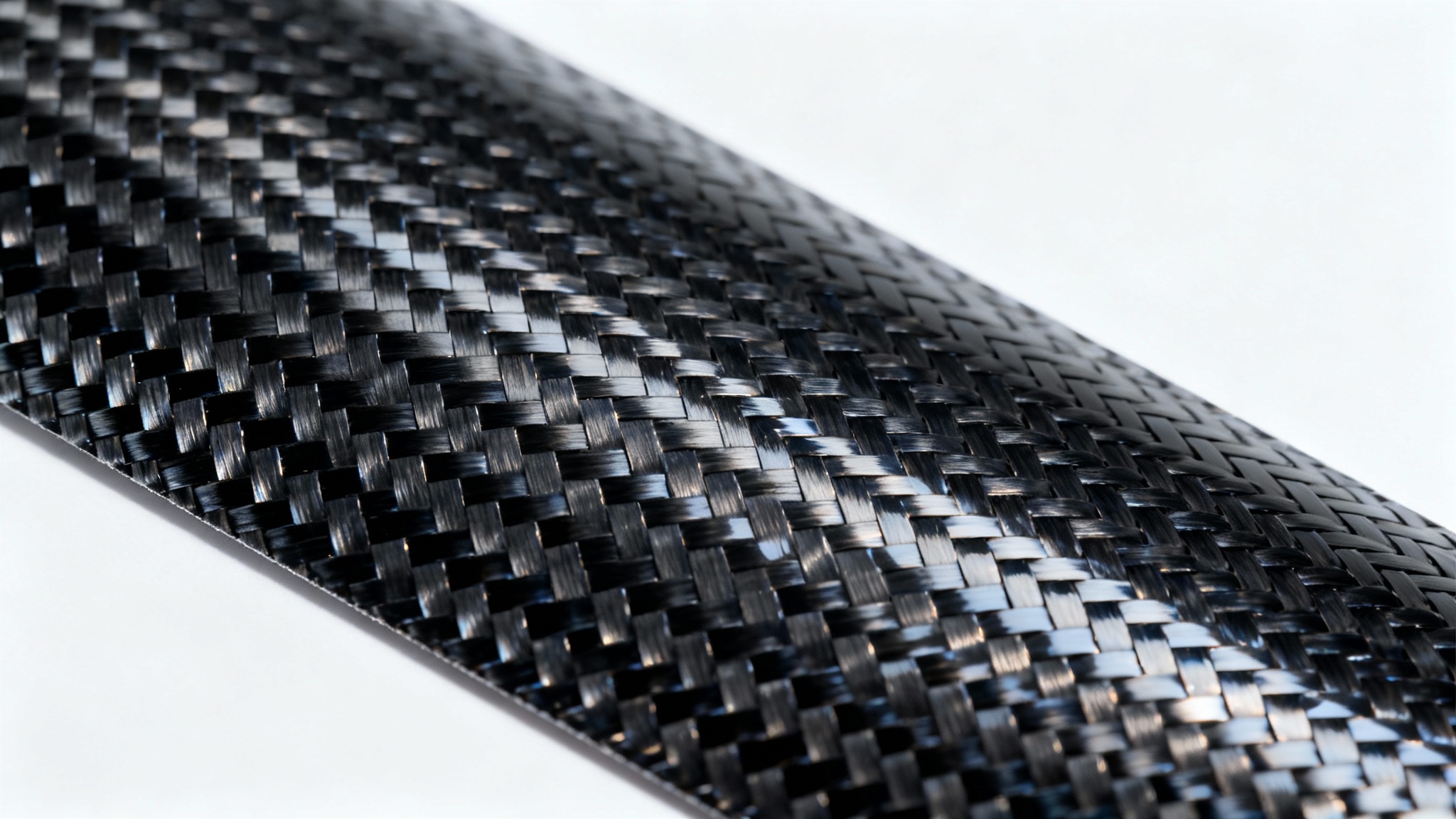 A detailed, high-resolution macro shot of a glossy black carbon fiber texture, highlighting its intricate woven pattern against a stark white background.