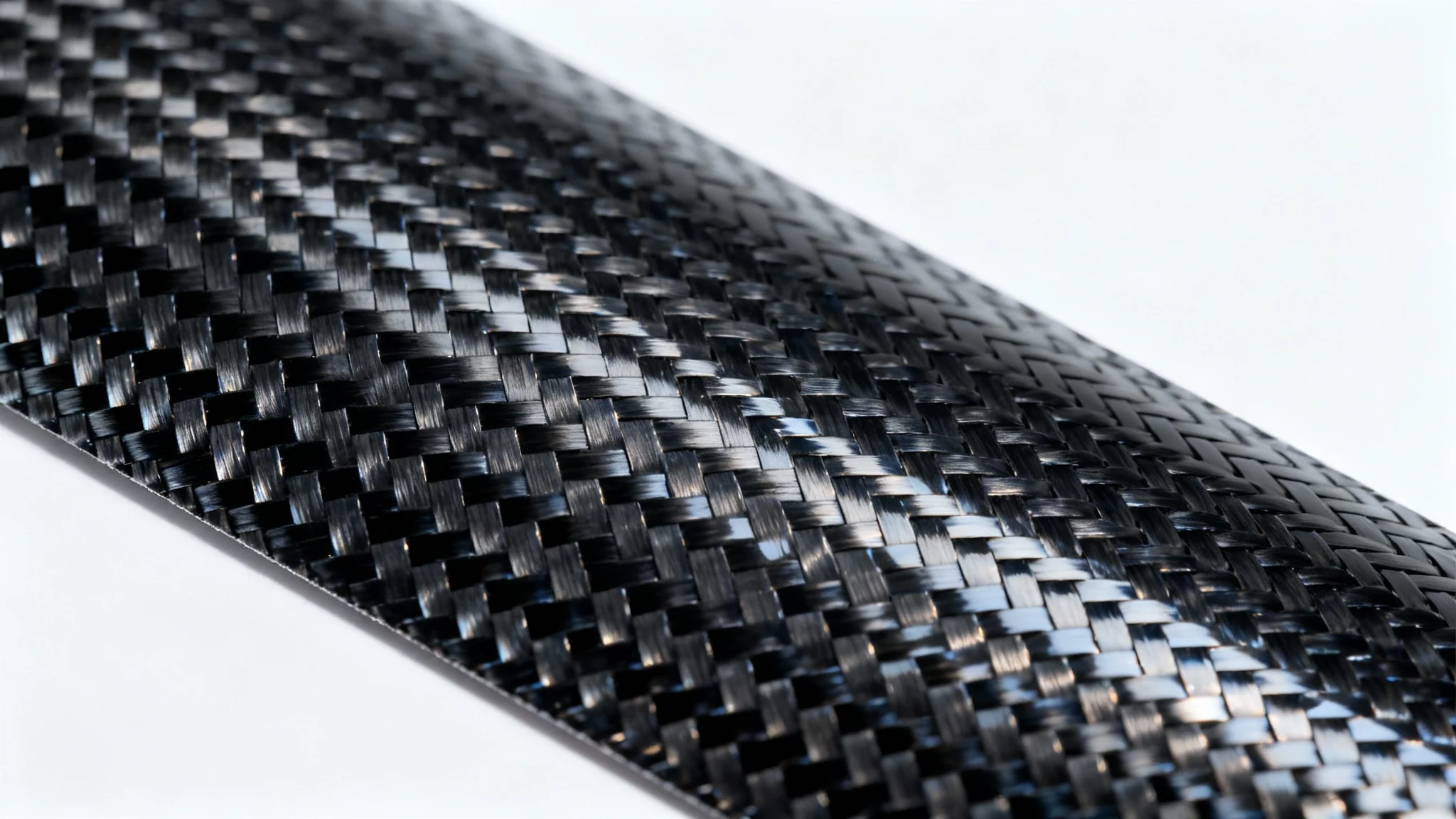 A detailed, high-resolution macro shot of a glossy black carbon fiber texture, highlighting its intricate woven pattern against a stark white background.