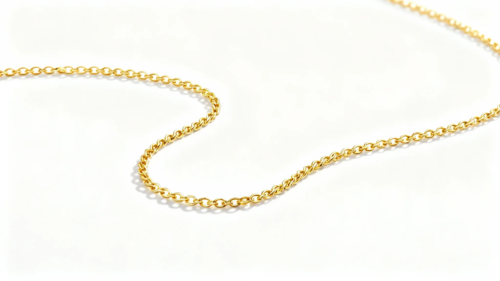 An elegant, high-end product photograph of a delicate gold necklace beautifully arranged on a pure white background, showcasing its fine details and luxurious shine.