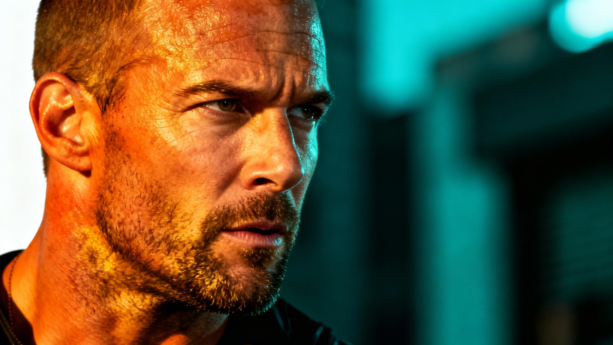 A cinematic portrait of a man with a rugged expression, demonstrating a classic Hollywood teal and orange color grade, with his warm skin tones set against a cool, dark teal background.