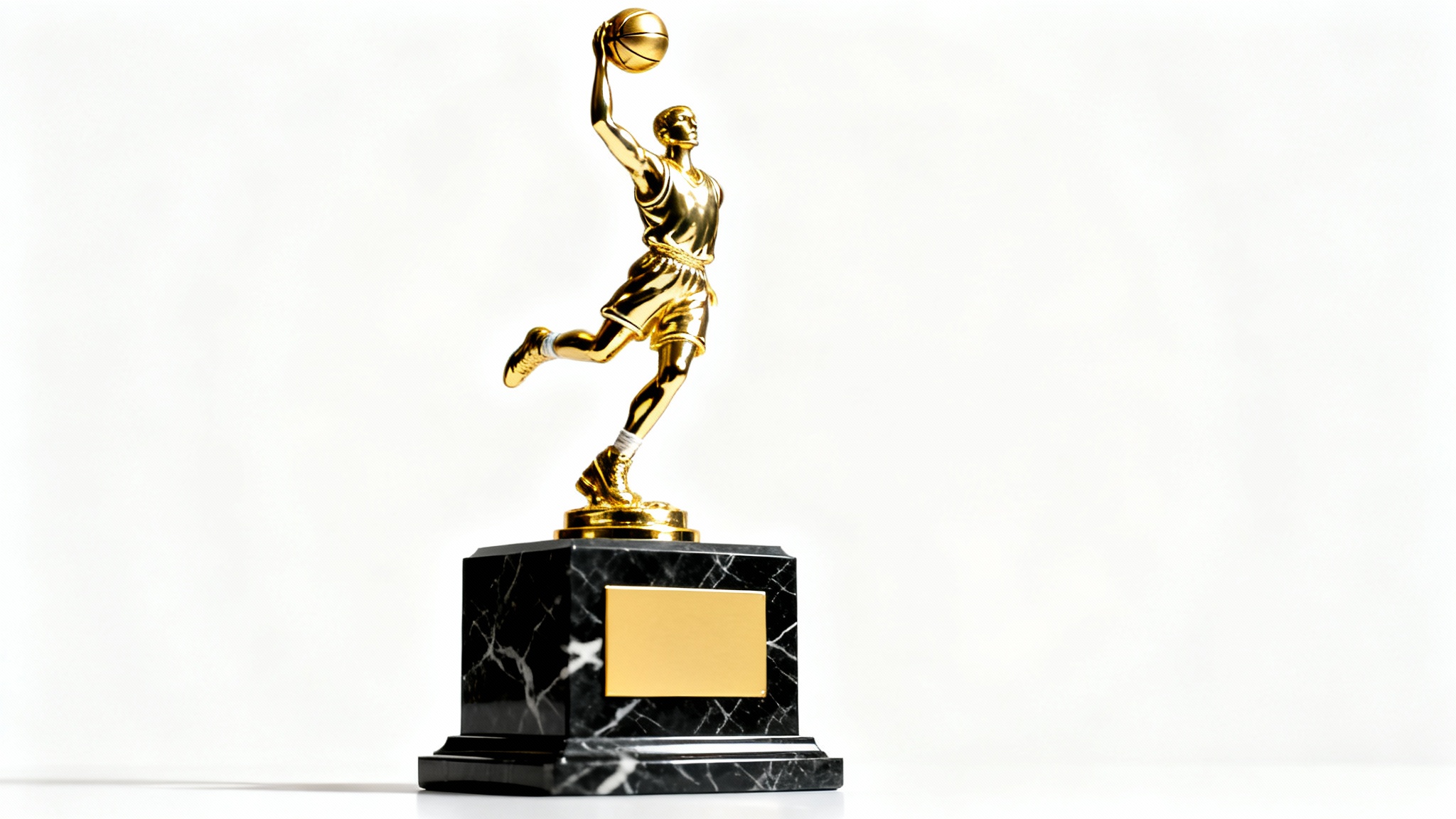 A close-up studio shot of a gleaming gold basketball trophy, featuring a player in a dunking pose on a polished black marble base, set against a solid white background.