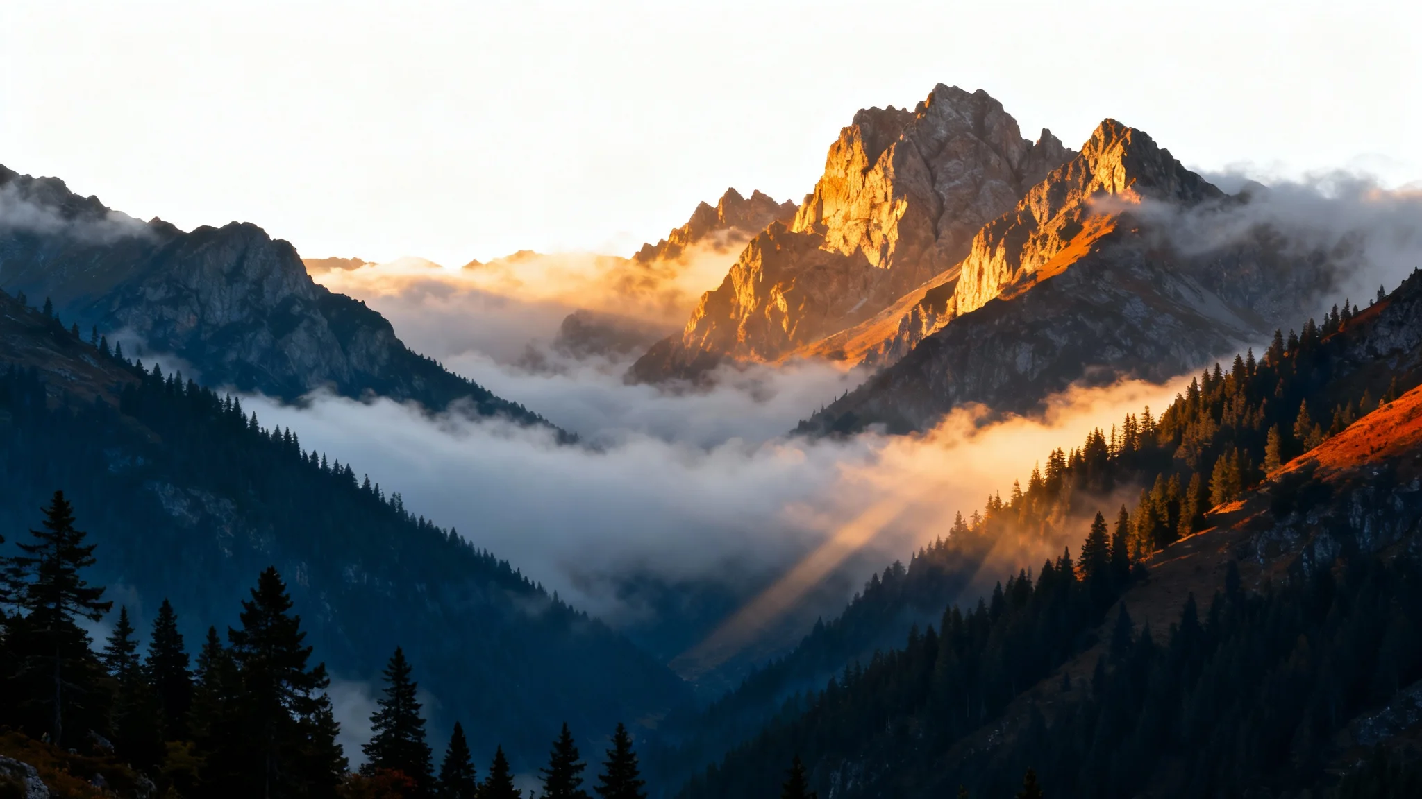 A majestic mountain landscape at sunrise, with a thick layer of fog filling the valleys, creating a serene and mystical atmosphere.