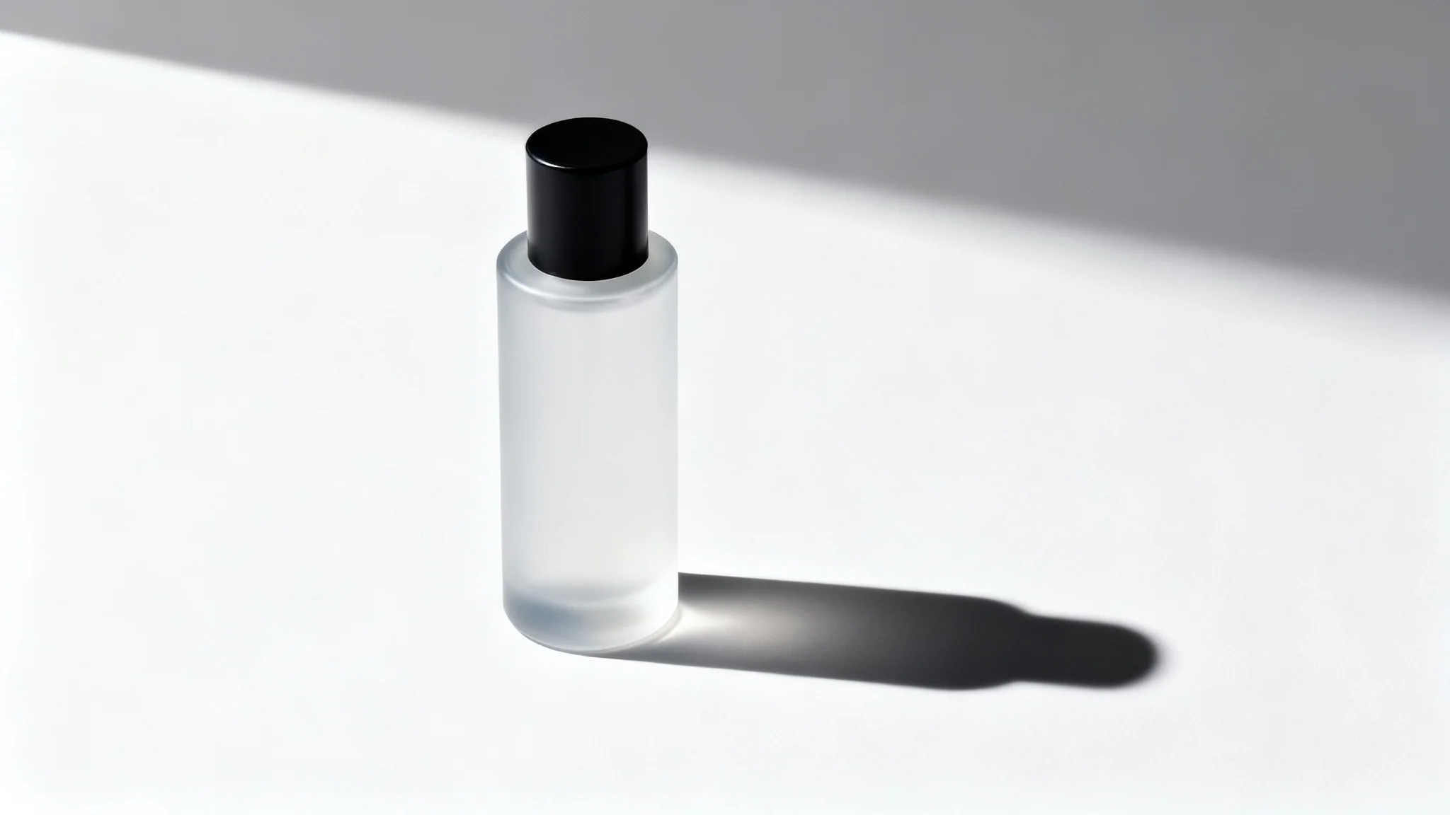 A photorealistic mockup of a sleek cosmetic bottle on a white background, casting a sharp and realistic shadow to its side, demonstrating a product shadow effect.