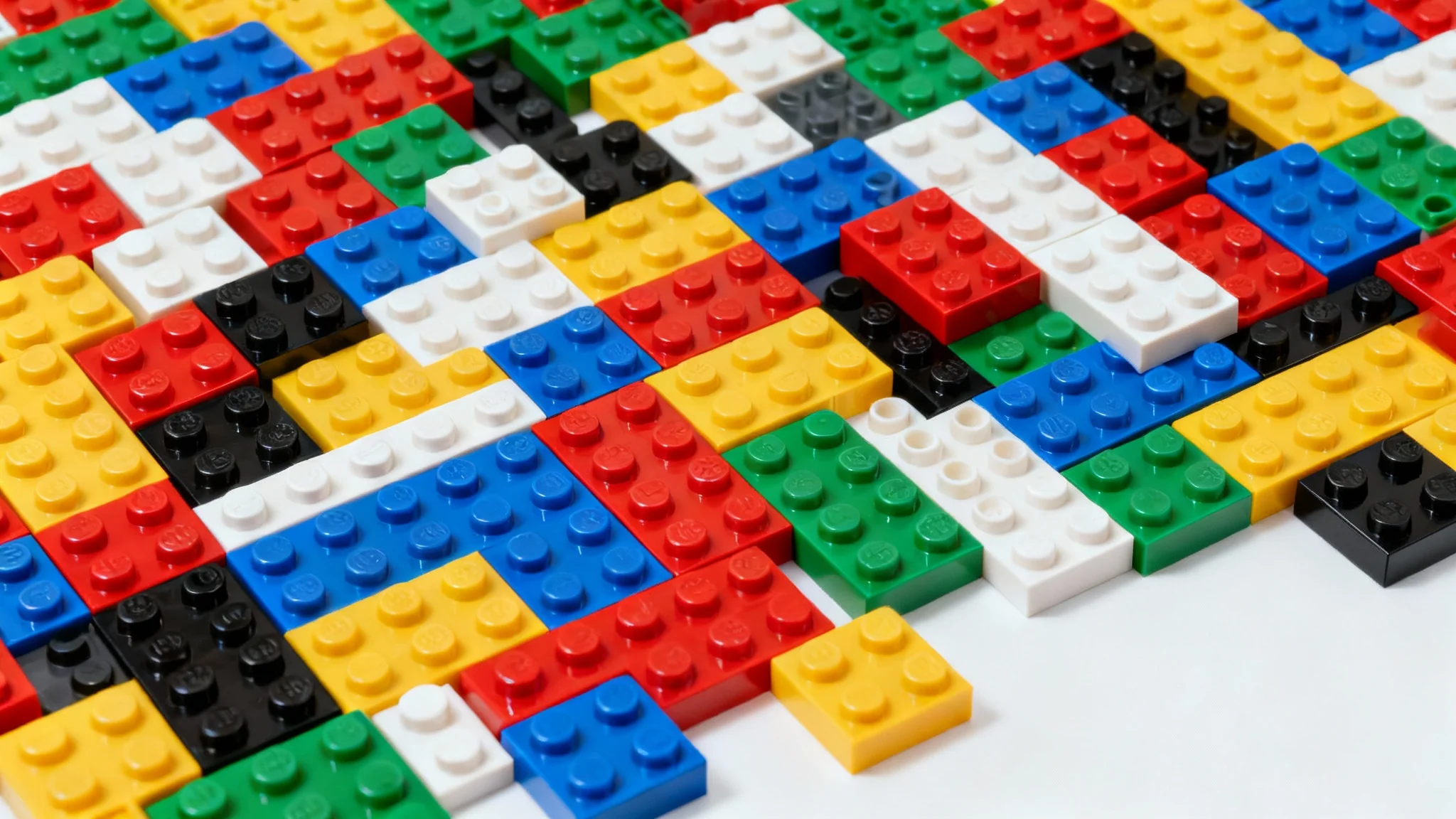 A close-up, top-down photograph of a vibrant background made entirely of colorful, interlocking Lego bricks in primary colors like red, blue, yellow, and green.