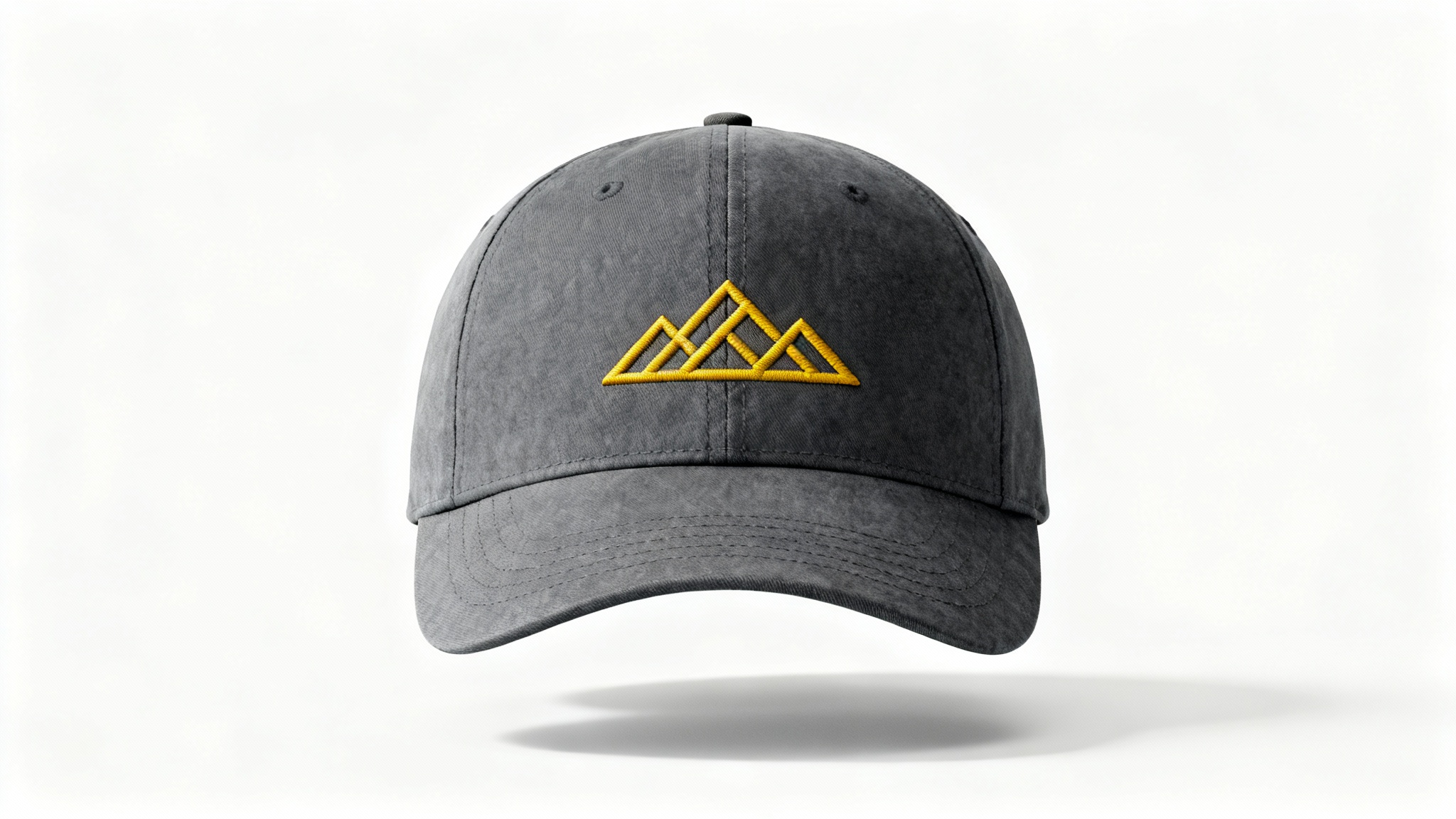 A photorealistic mockup of a charcoal gray dad hat featuring a minimalist golden-yellow embroidered mountain range logo, presented on a clean white background.