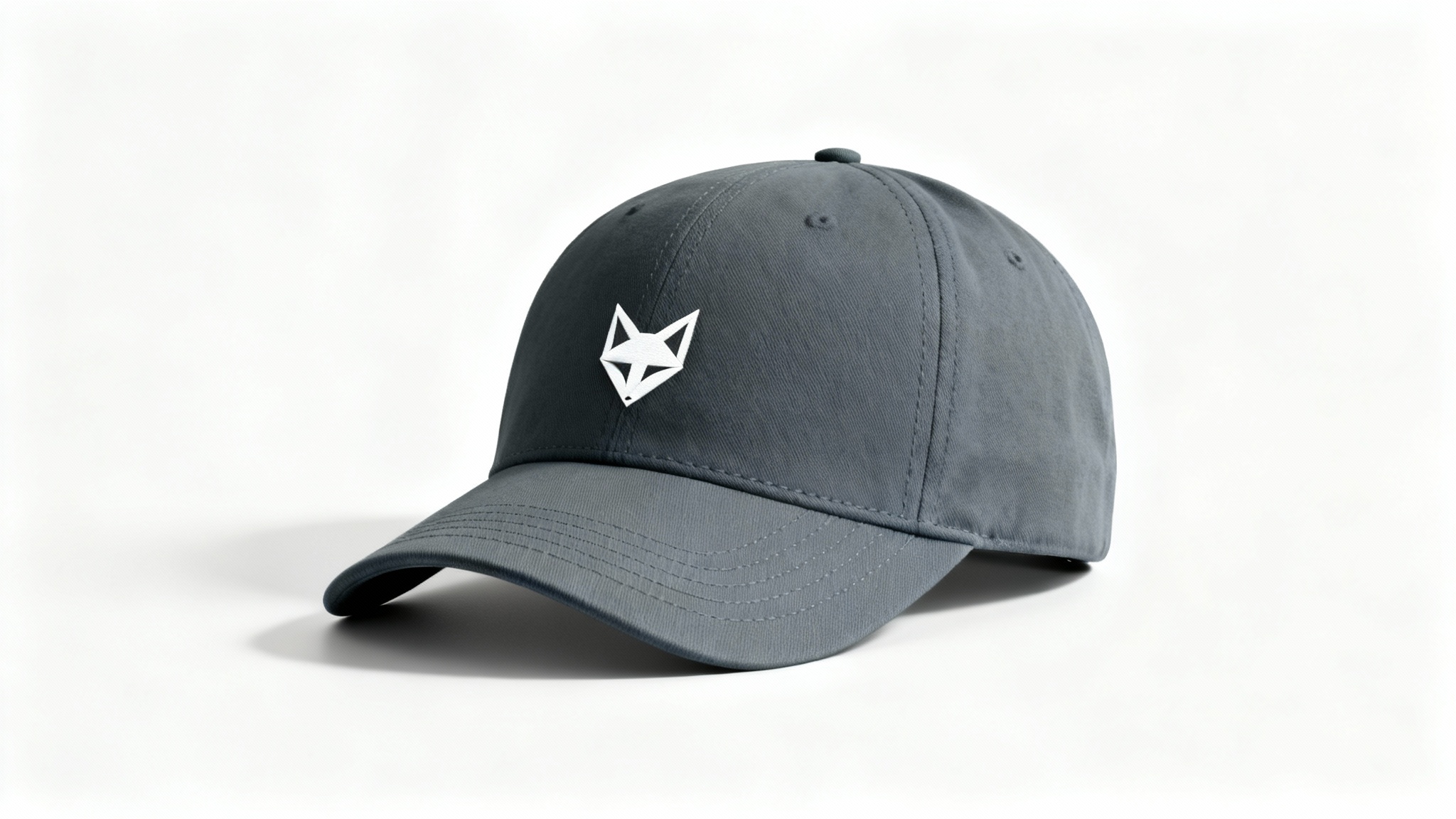 A product mockup of a charcoal grey dad hat with a minimalist white geometric fox logo embroidered on the front, set against a clean white background.