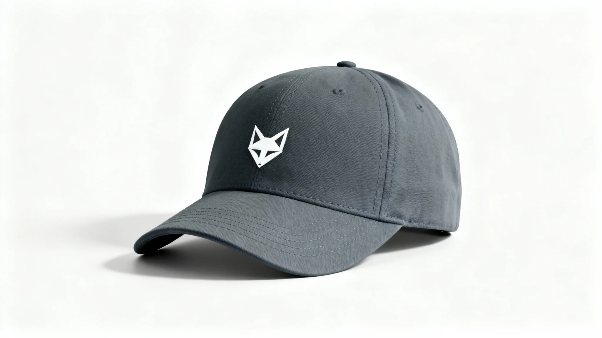 A product mockup of a charcoal grey dad hat with a minimalist white geometric fox logo embroidered on the front, set against a clean white background.