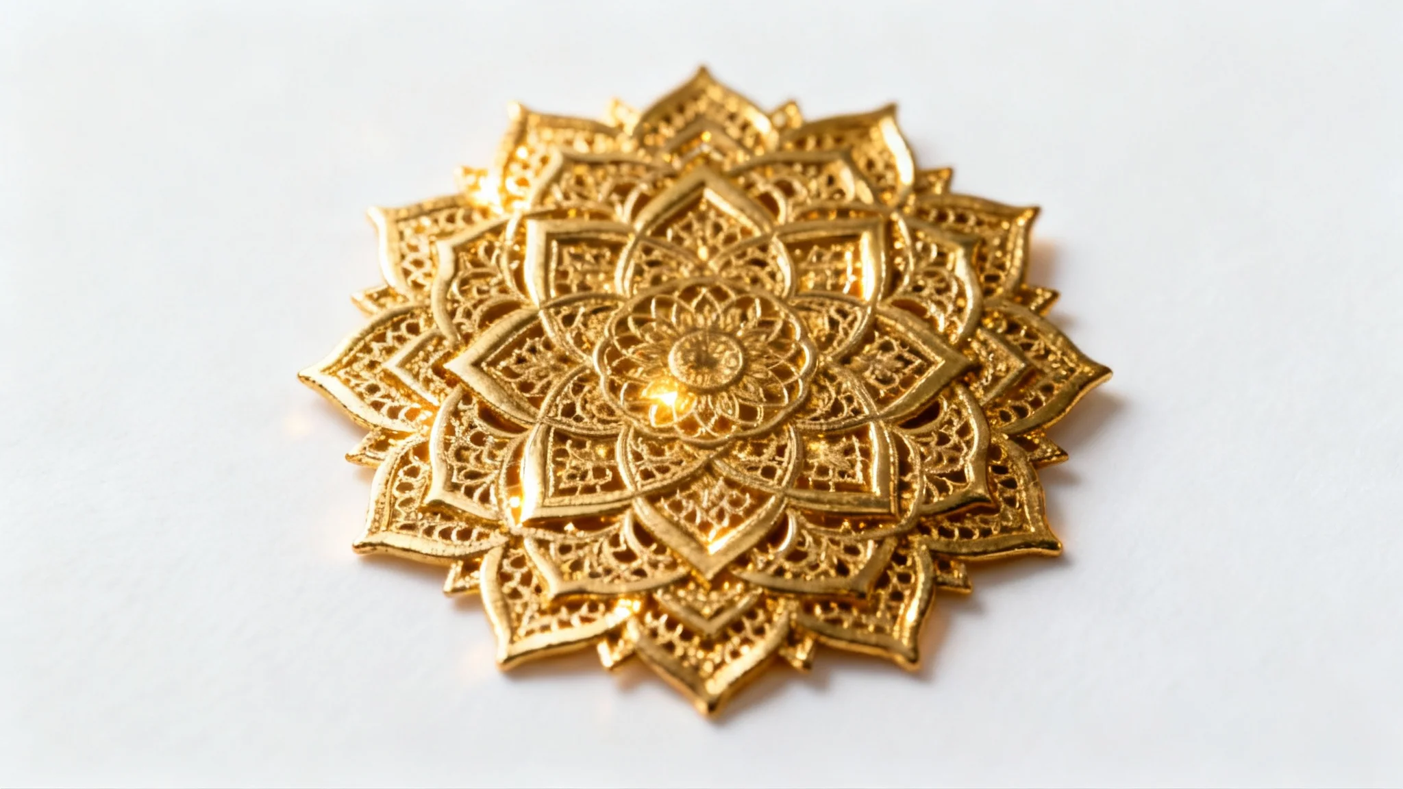 An intricate, symmetrical gold mandala with a polished metallic finish, shown in a detailed close-up against a plain white background.