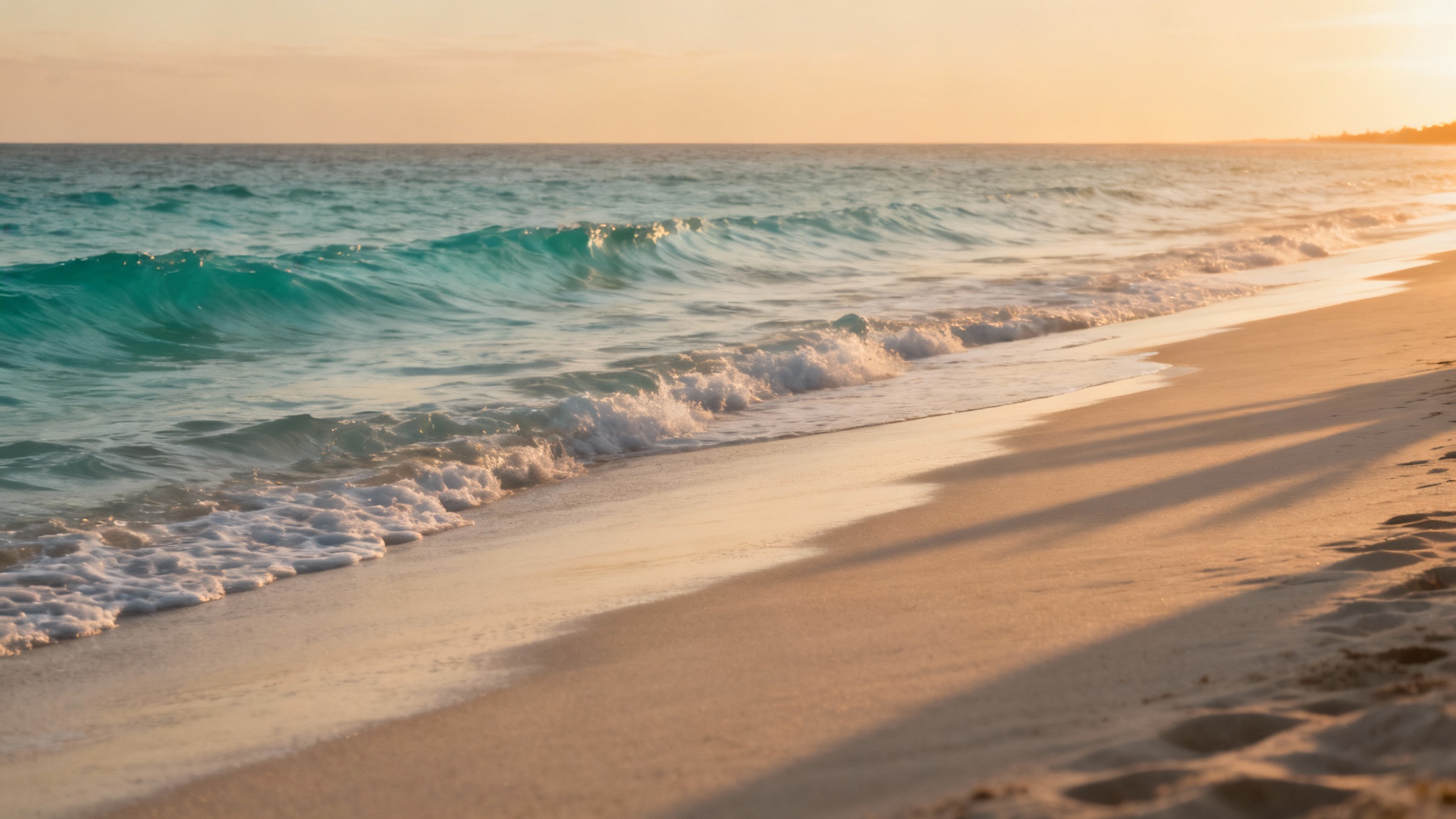 A perfect, empty beach at sunset with smooth sand and gentle waves. The image is completely free of people or other distractions, showcasing the final result of an inpainting tool.