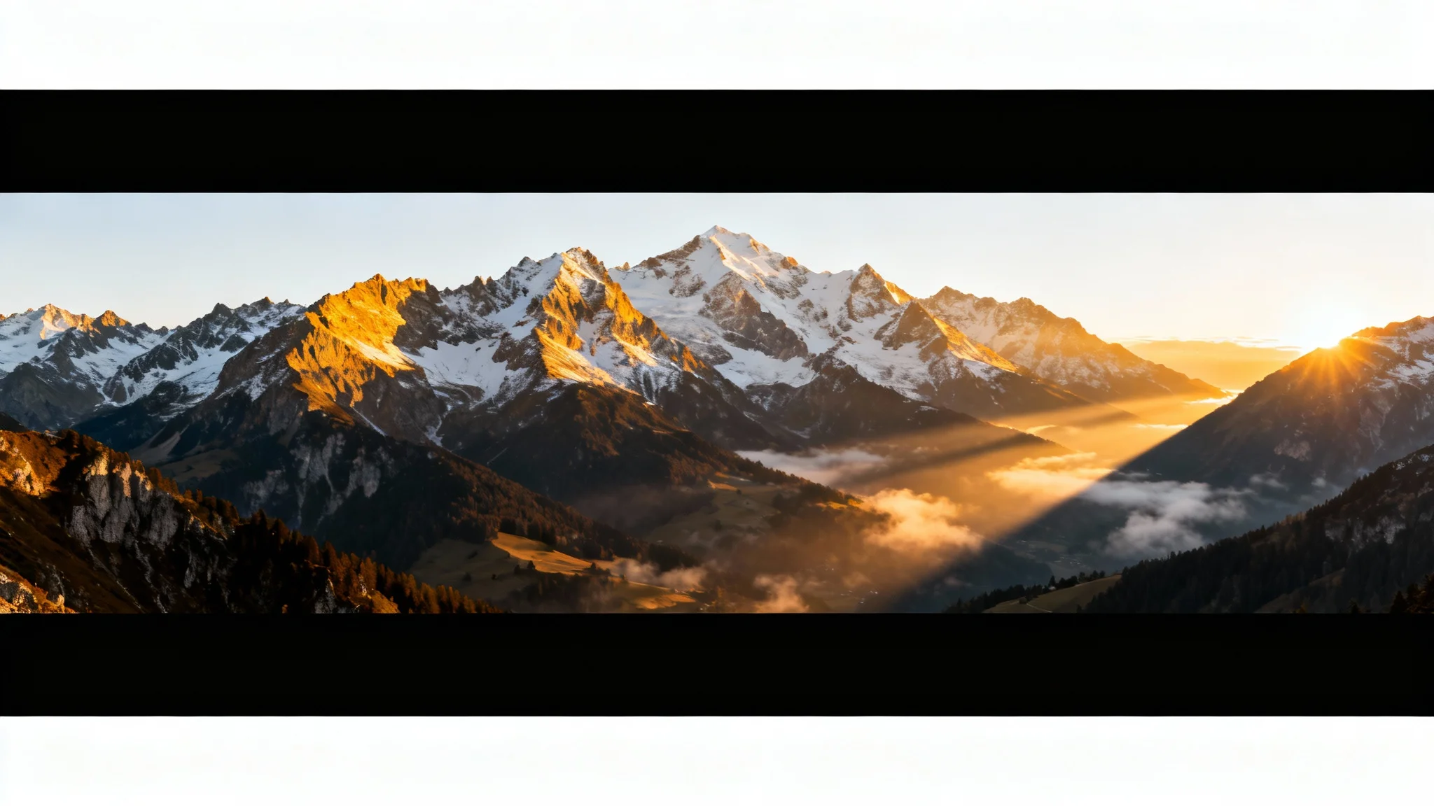 A dramatic landscape photo of a mountain range at sunrise, edited with black letterbox bars at the top and bottom to create a cinematic widescreen effect, displayed on a white background.