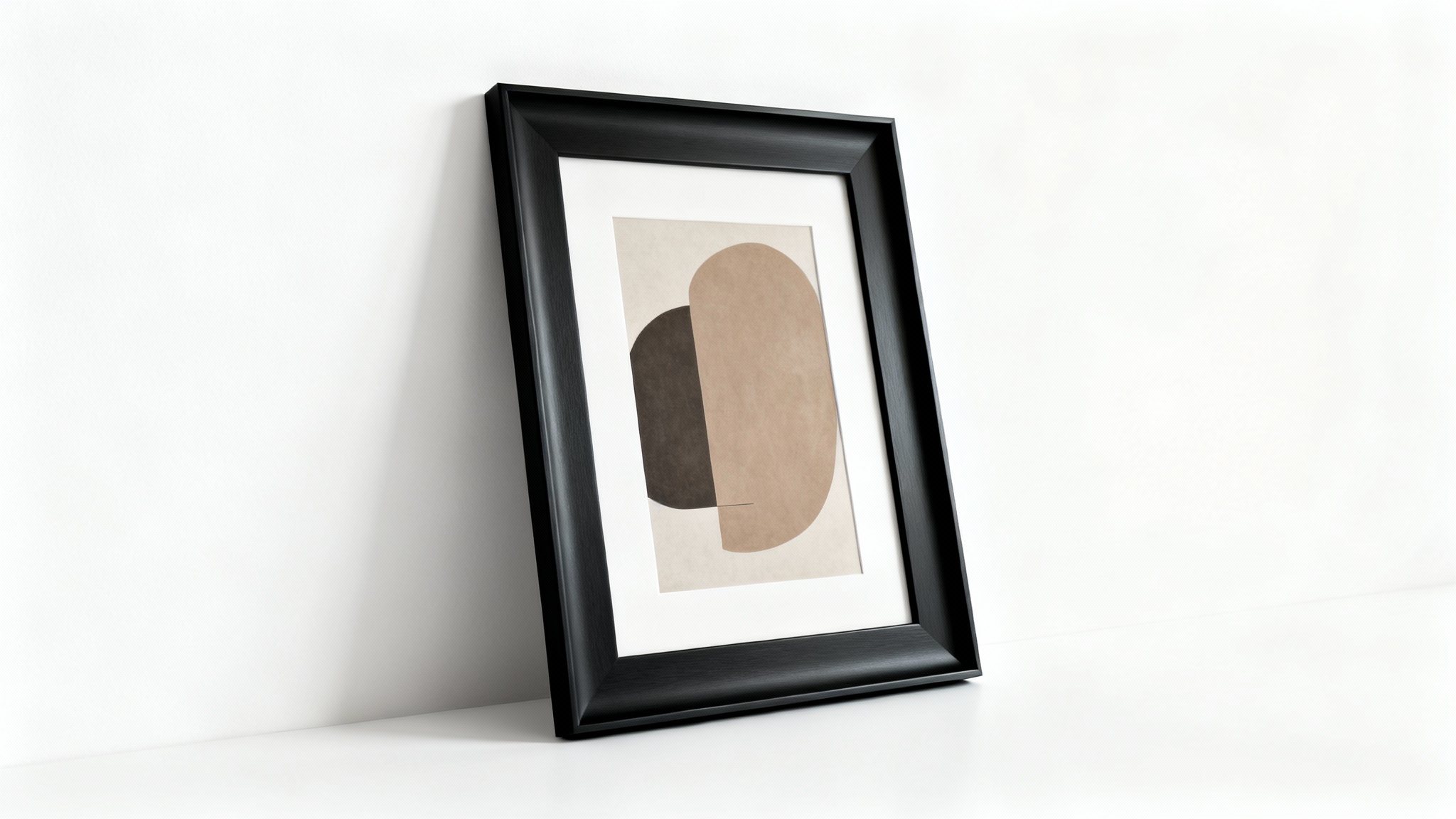 A modern black picture frame mockup with a matte finish, containing an abstract art print and leaning against a clean white wall.
