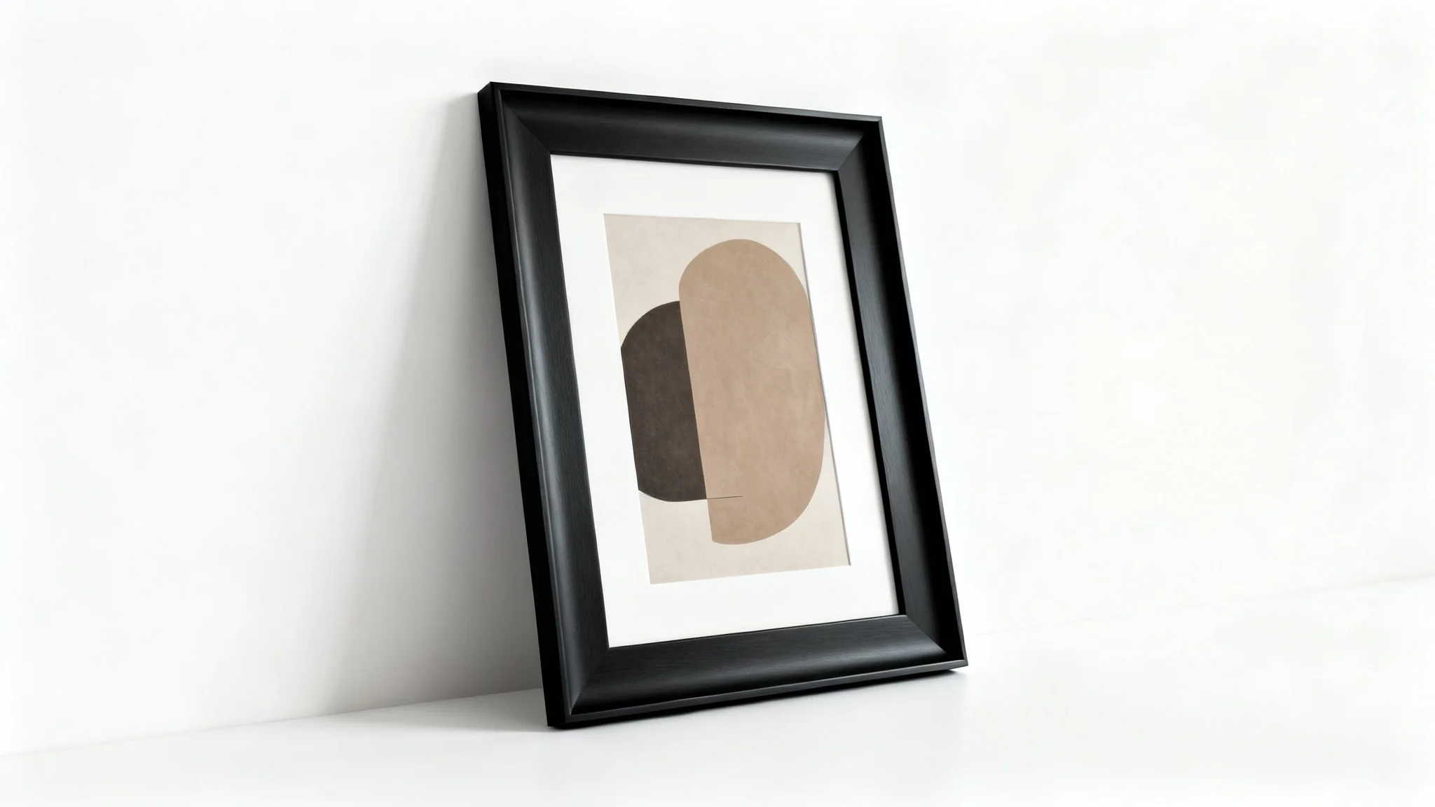 A modern black picture frame mockup with a matte finish, containing an abstract art print and leaning against a clean white wall.