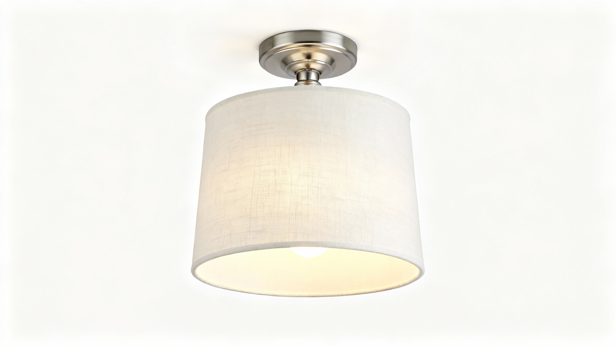 A modern semi-flush drum light with a textured off-white fabric shade and brushed nickel hardware, illuminated against a clean white background.