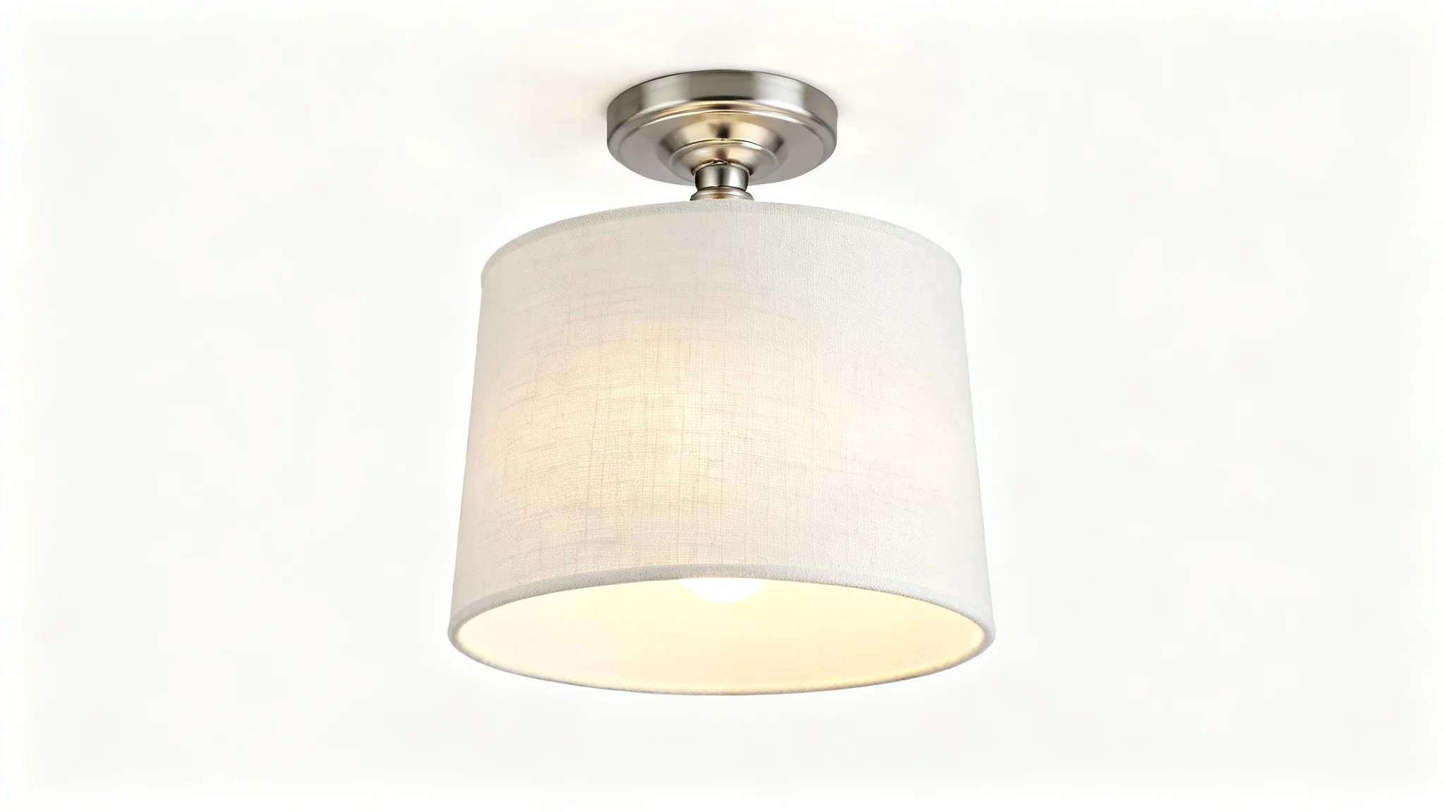 A modern semi-flush drum light with a textured off-white fabric shade and brushed nickel hardware, illuminated against a clean white background.