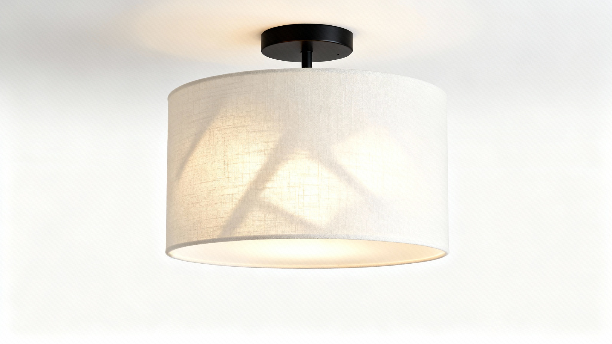 A photorealistic mockup of a modern semi-flush drum light with a textured white fabric shade and matte black base, illuminated against a clean white background.