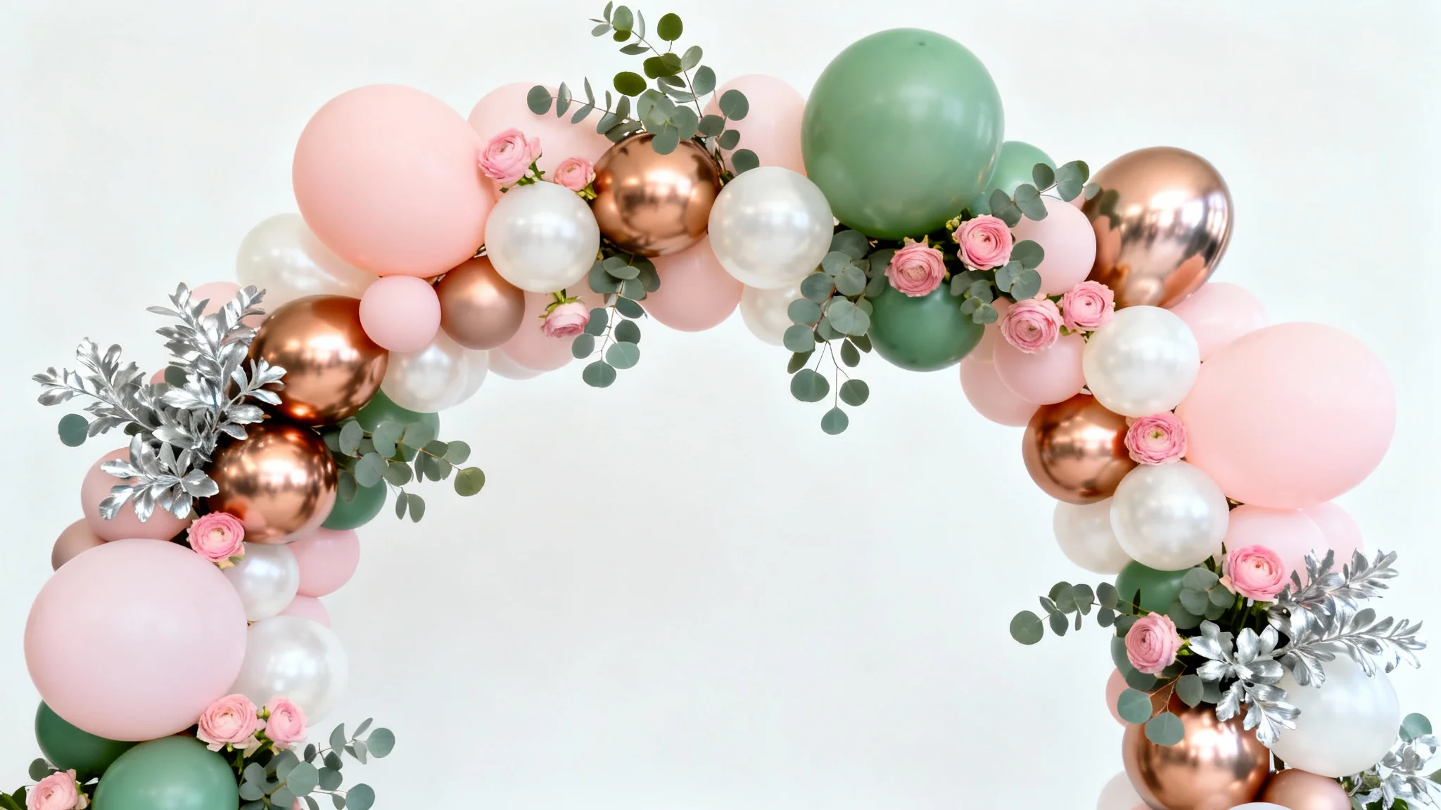 A beautiful, organic balloon arch with pink, rose gold, and white balloons, accented with eucalyptus leaves, professionally photographed against a plain white background.