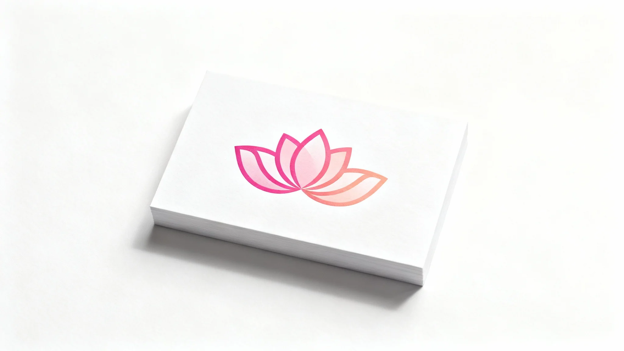 A modern and elegant flower logo mockup, featuring a stylized abstract flower in a pink and peach gradient, professionally printed on a white business card resting on a plain white background.