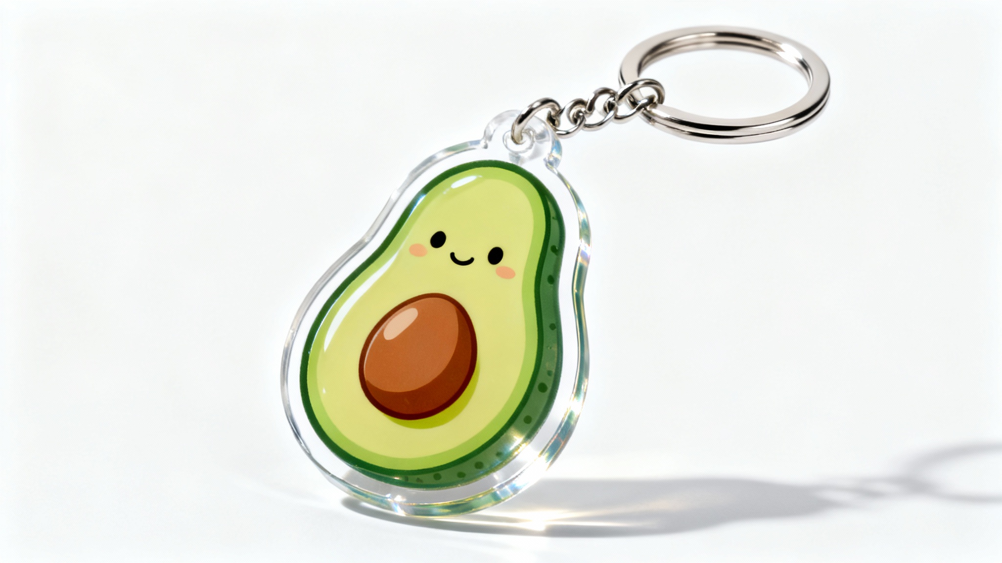 A close-up product mockup of a custom-shaped clear acrylic keychain designed as a cute cartoon avocado, attached to a metal ring, set against a plain white background.