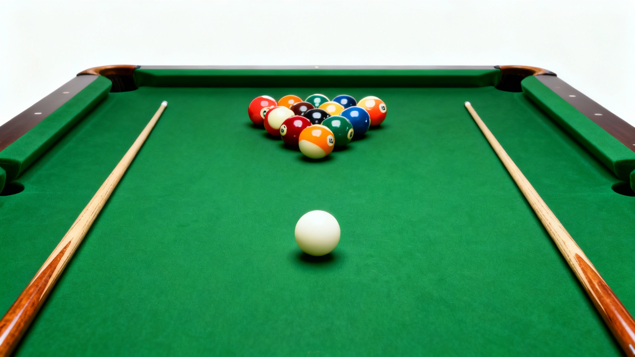 A minimalist top-down photo of a green felt pool table with a racked set of billiard balls and two cue sticks, all isolated on a clean white background.