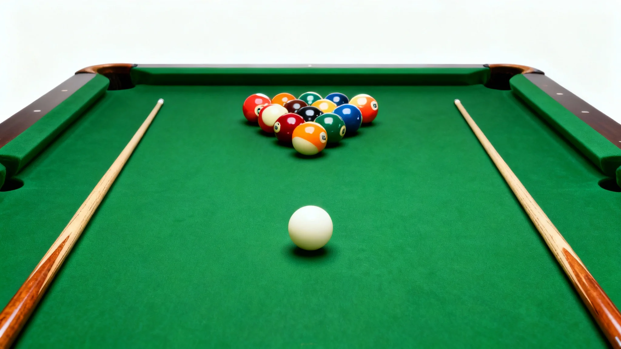 A minimalist top-down photo of a green felt pool table with a racked set of billiard balls and two cue sticks, all isolated on a clean white background.