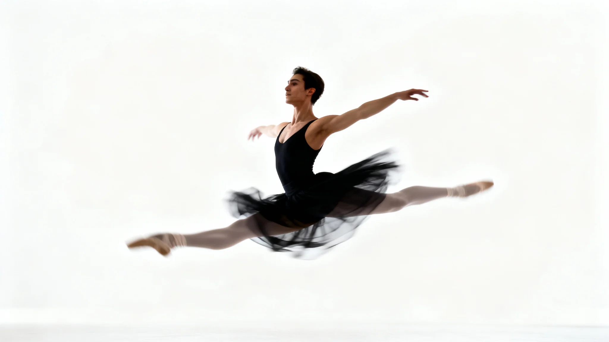 A dancer frozen in mid-air against a white background, with their body in focus and their limbs showing a motion blur effect to illustrate speed and movement.