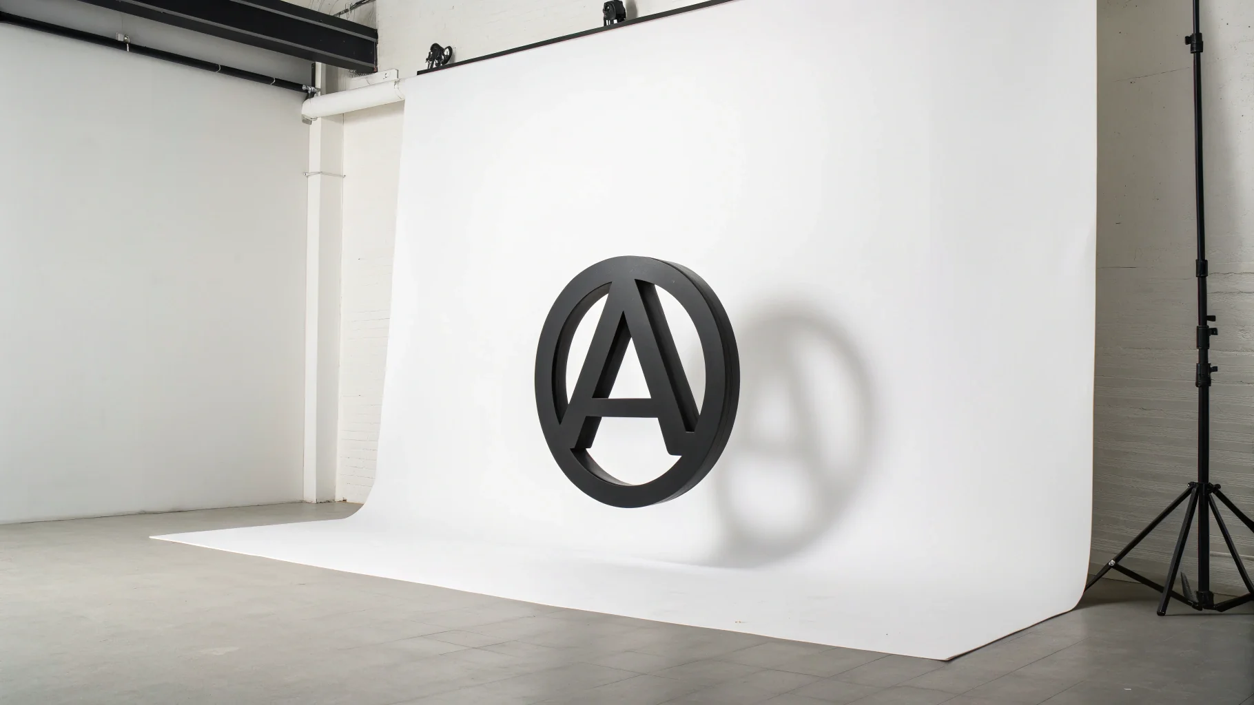 A modern, minimalist lettermark logo combining the letters 'A' and 'V' in a sleek, geometric design. The logo is matte black and presented on a clean white background.