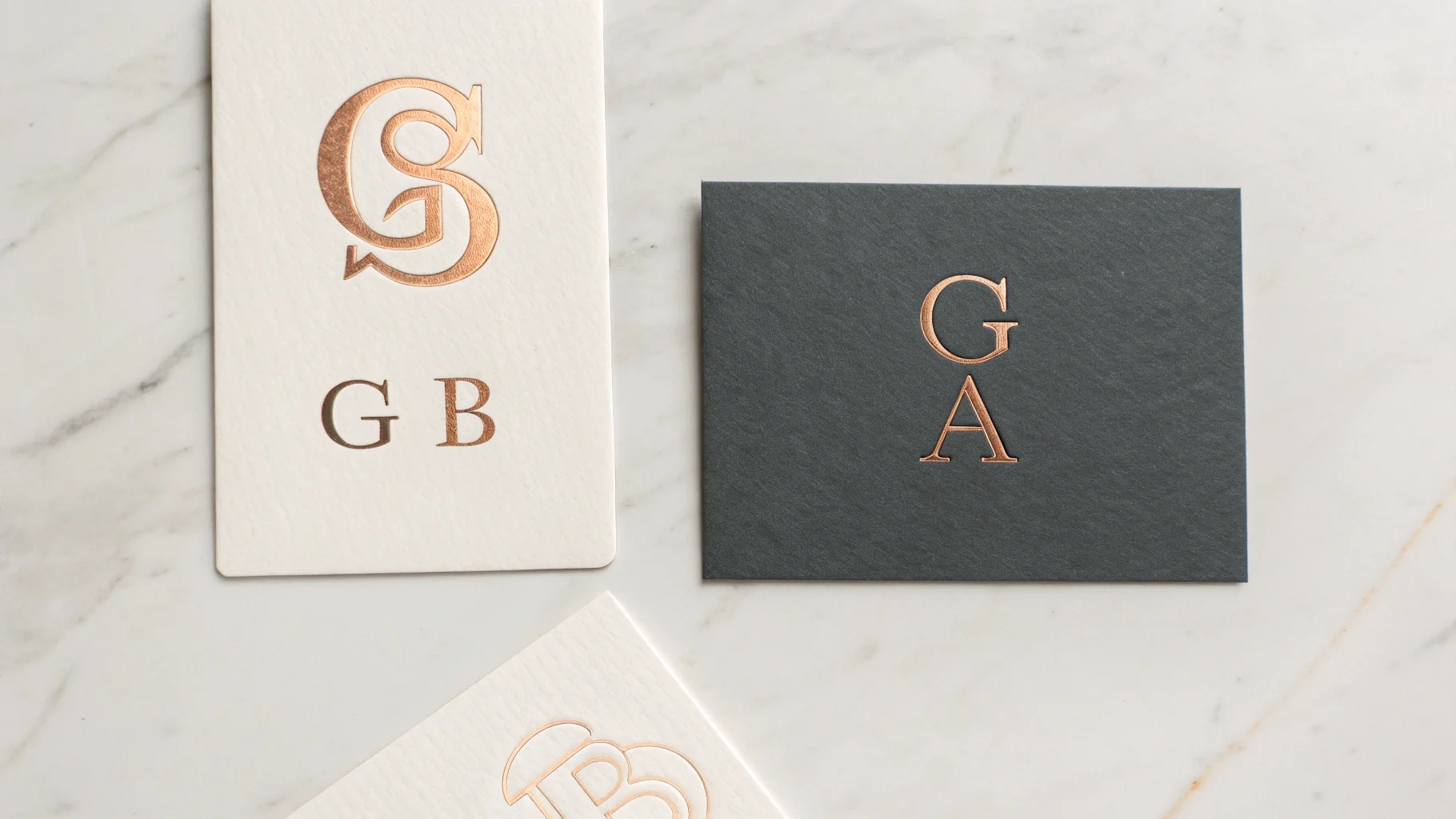 A professional mockup displaying three different styles of memorable lettermark and monogram logos for fictional brands on a clean white background.