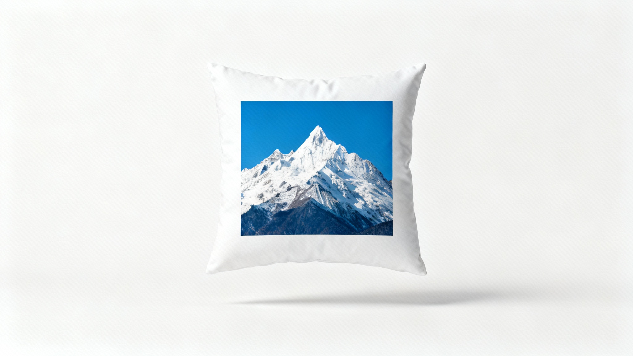 A central photograph of a snow-capped mountain, framed by a thick white border to represent image padding, set against a clean white background.