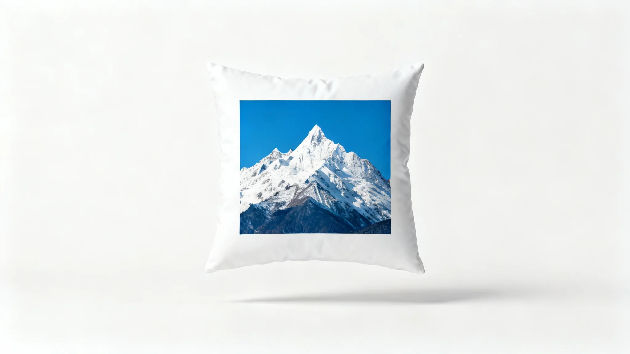 A central photograph of a snow-capped mountain, framed by a thick white border to represent image padding, set against a clean white background.