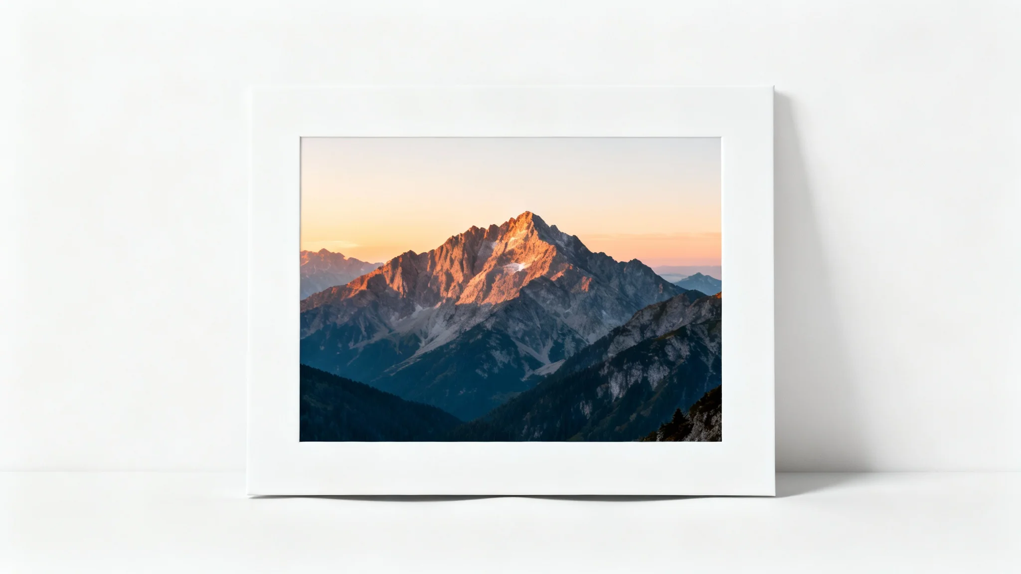 A minimalist mockup displaying a photograph of a mountain range. The photo has a prominent white border around it, illustrating the feature of adding padding to an image.