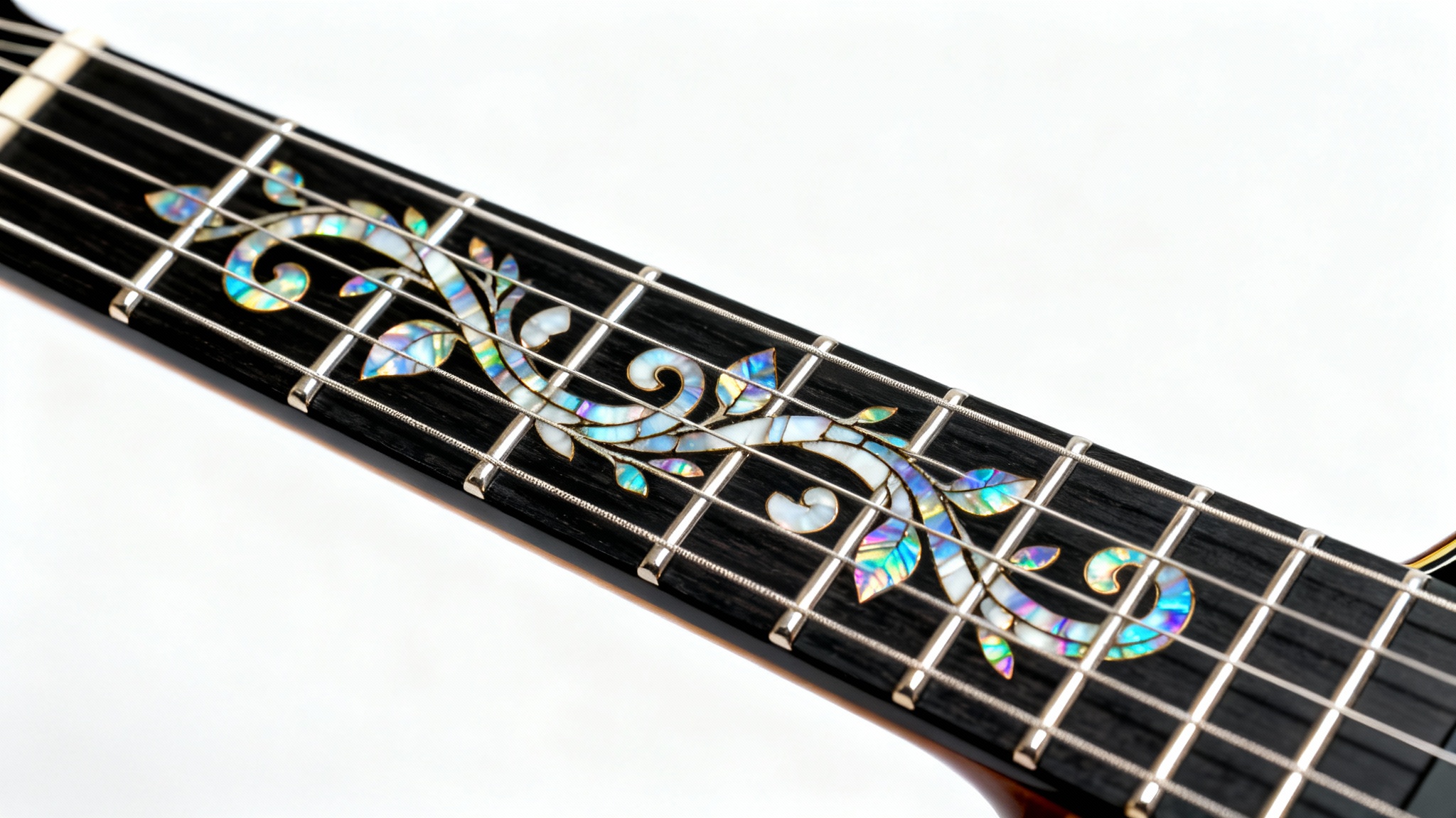 A detailed close-up of a dark ebony guitar fretboard, showcasing a beautiful and intricate vine inlay made of shimmering mother-of-pearl, on a clean white background.