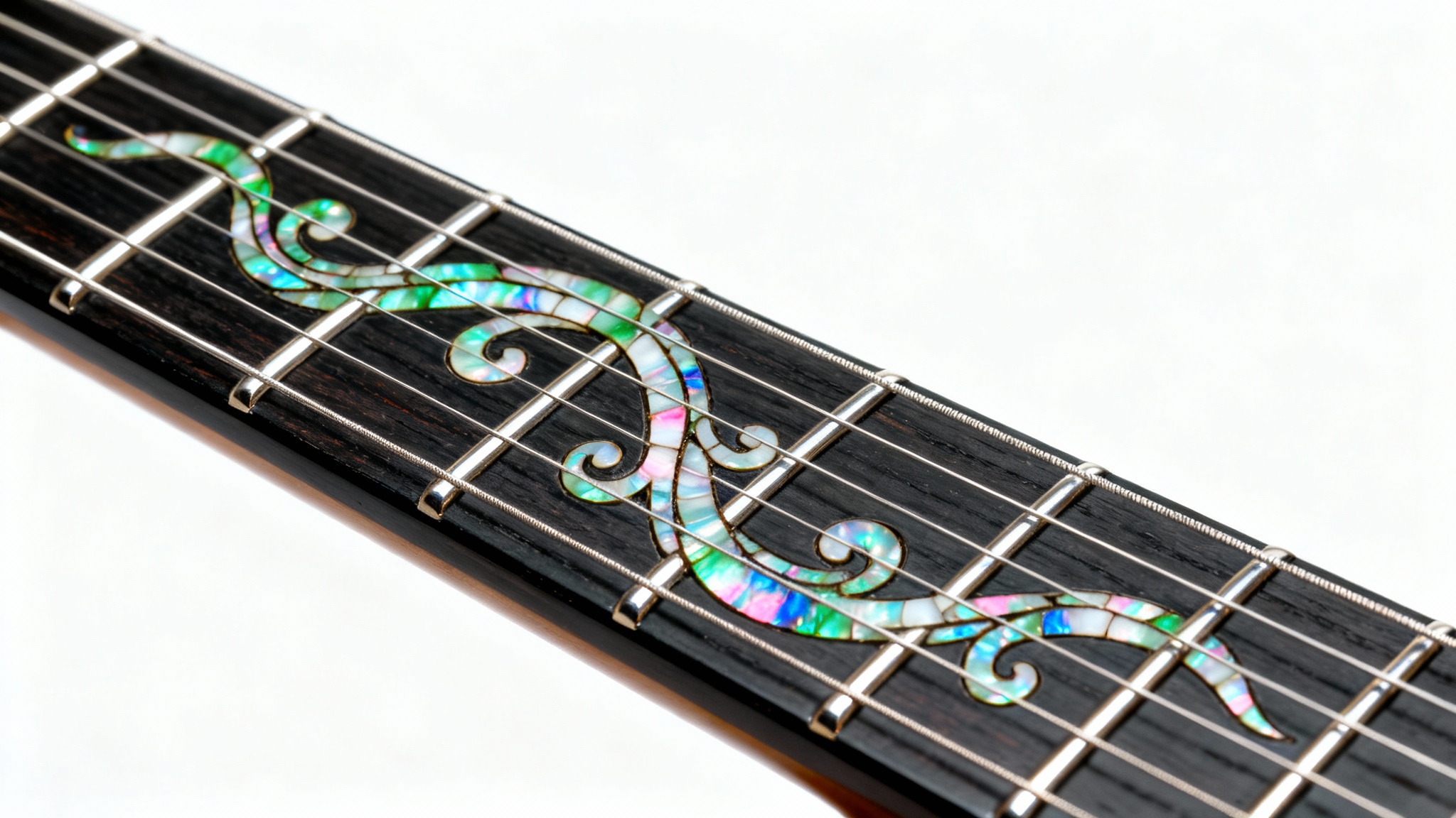 A detailed macro shot of a dark ebony guitar fretboard, showcasing a beautiful and intricate vine-like inlay made of iridescent mother-of-pearl between the metal frets, set against a plain white background.