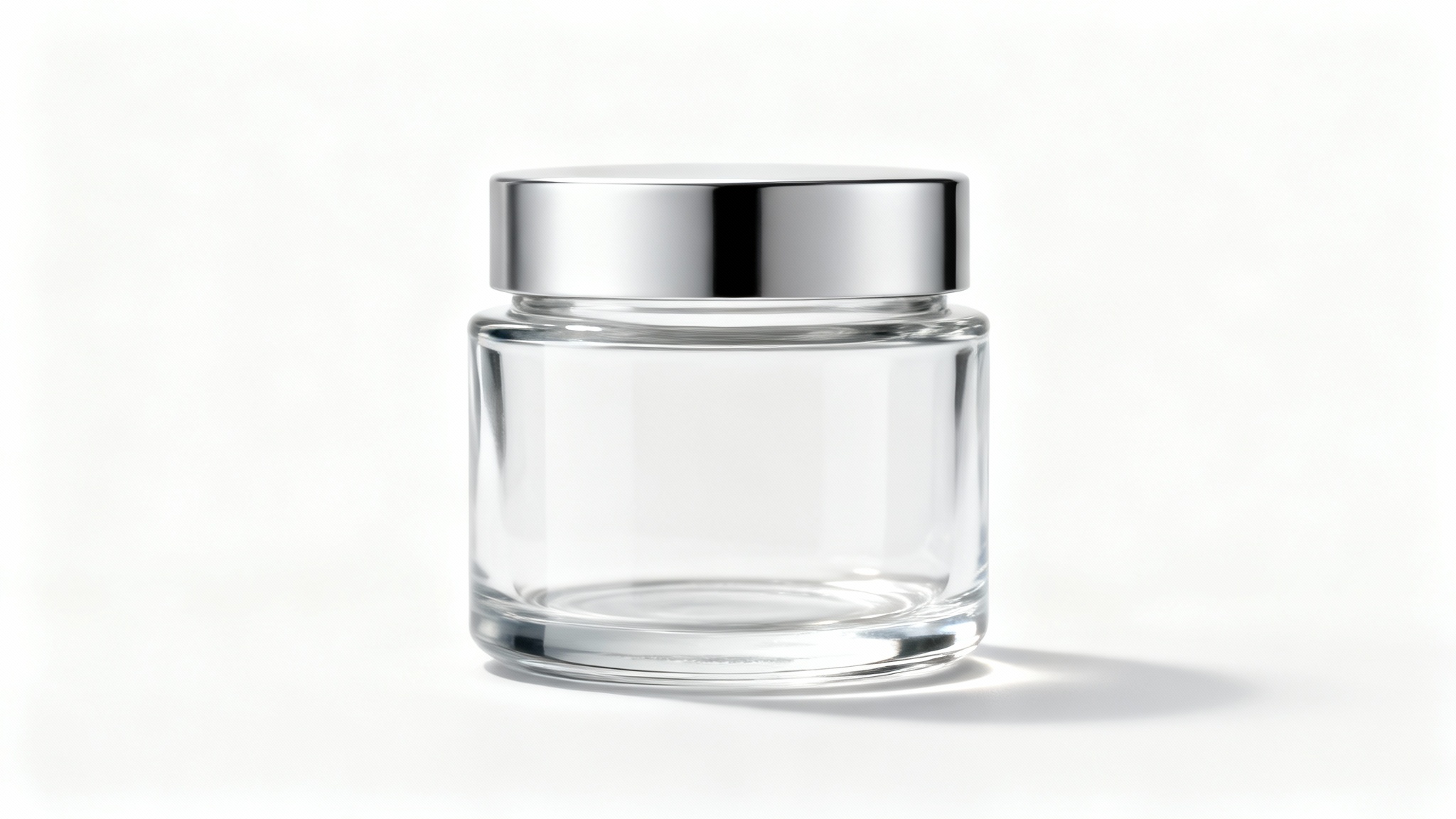 A photorealistic mockup of a single, empty, clear glass jar with a silver lid, isolated on a clean white background.