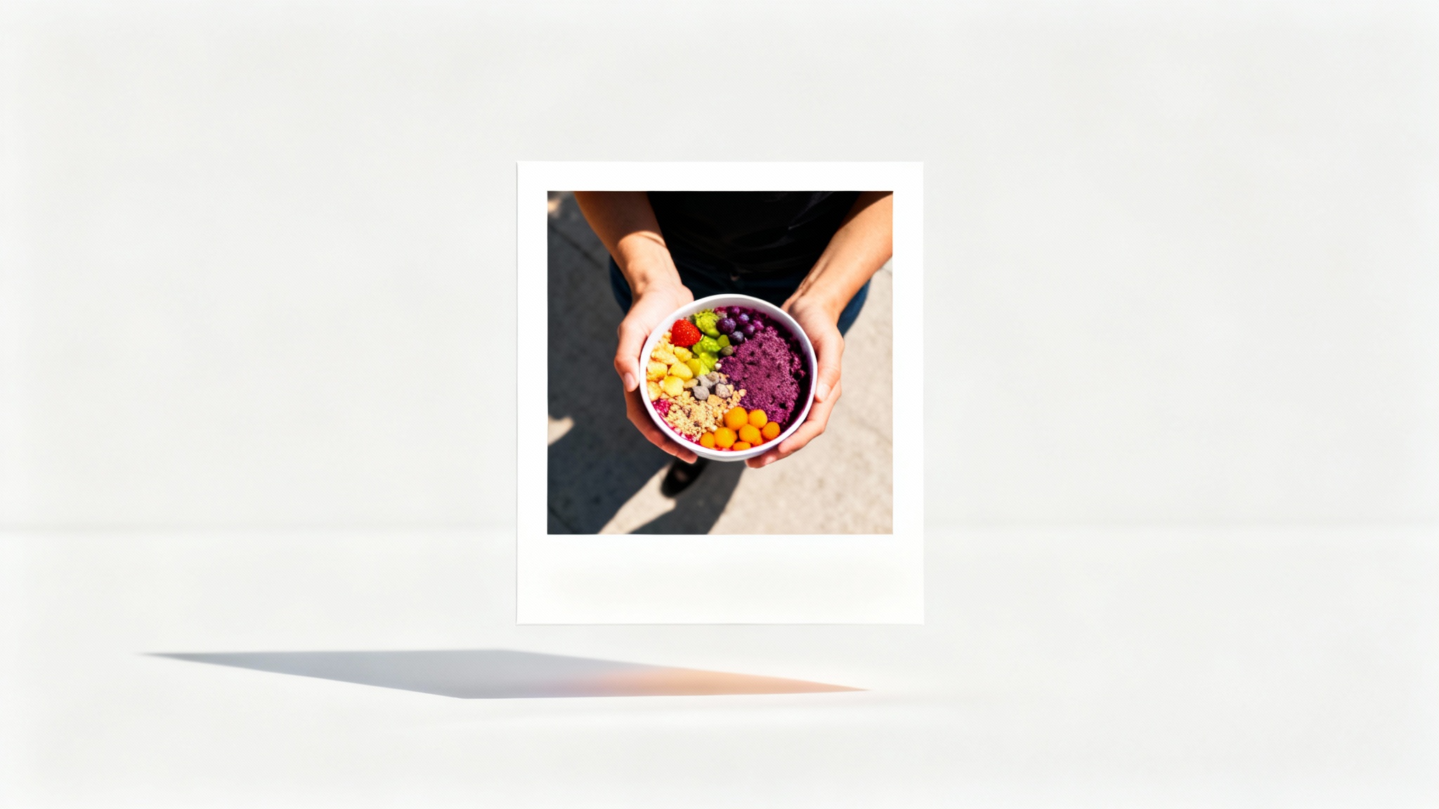 A mockup of an Instagram post featuring a top-down photo of an acai bowl, framed by a clean and thick white border, against a plain background.