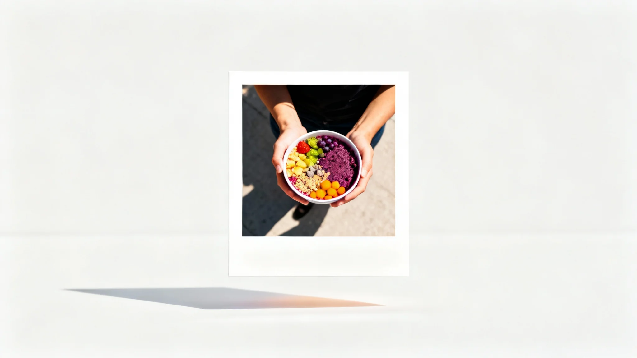 A mockup of an Instagram post featuring a top-down photo of an acai bowl, framed by a clean and thick white border, against a plain background.