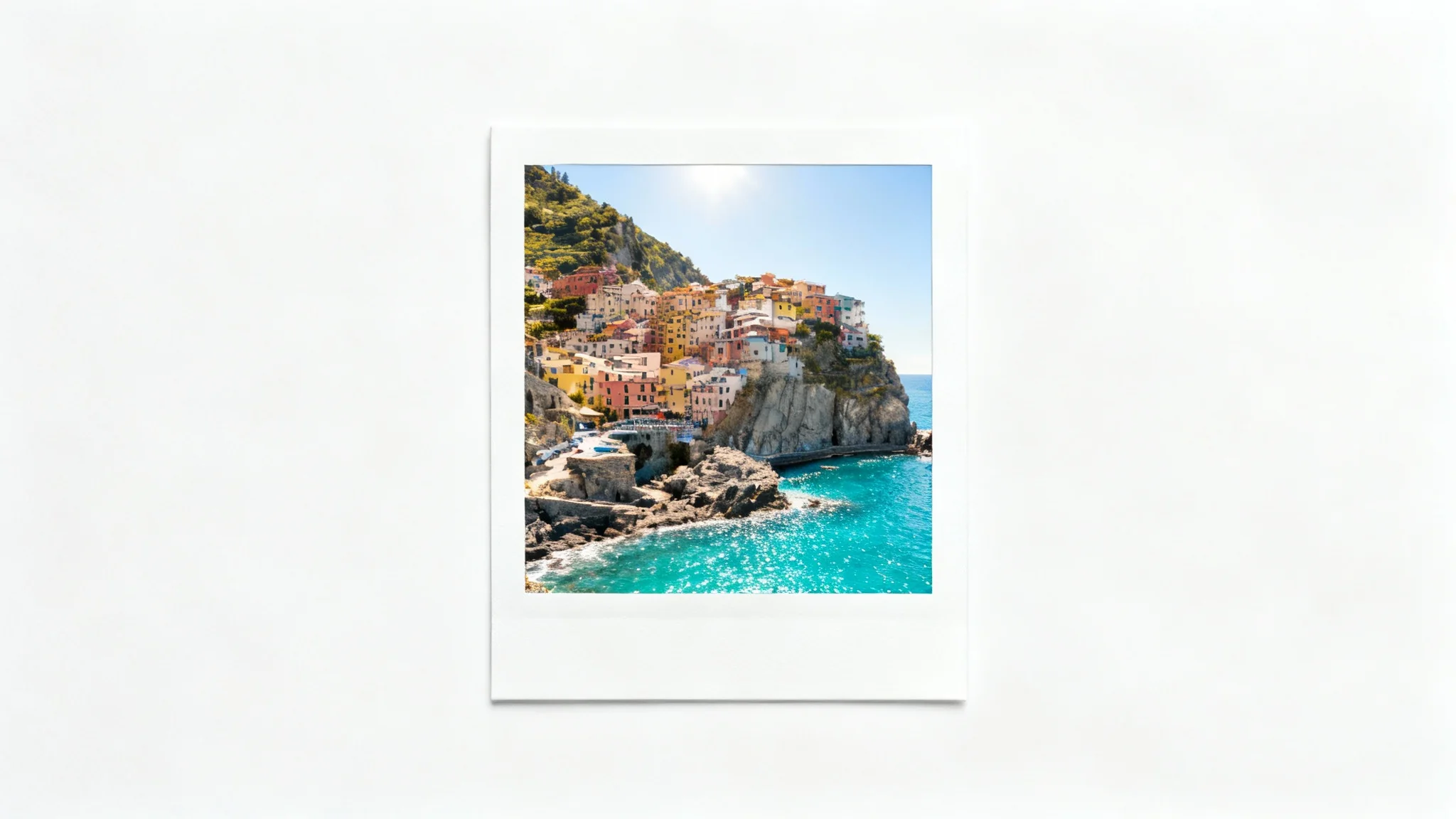A mockup of an Instagram photo with a thick white border. The photo inside shows a colorful European coastal village. The entire image is on a plain white background.