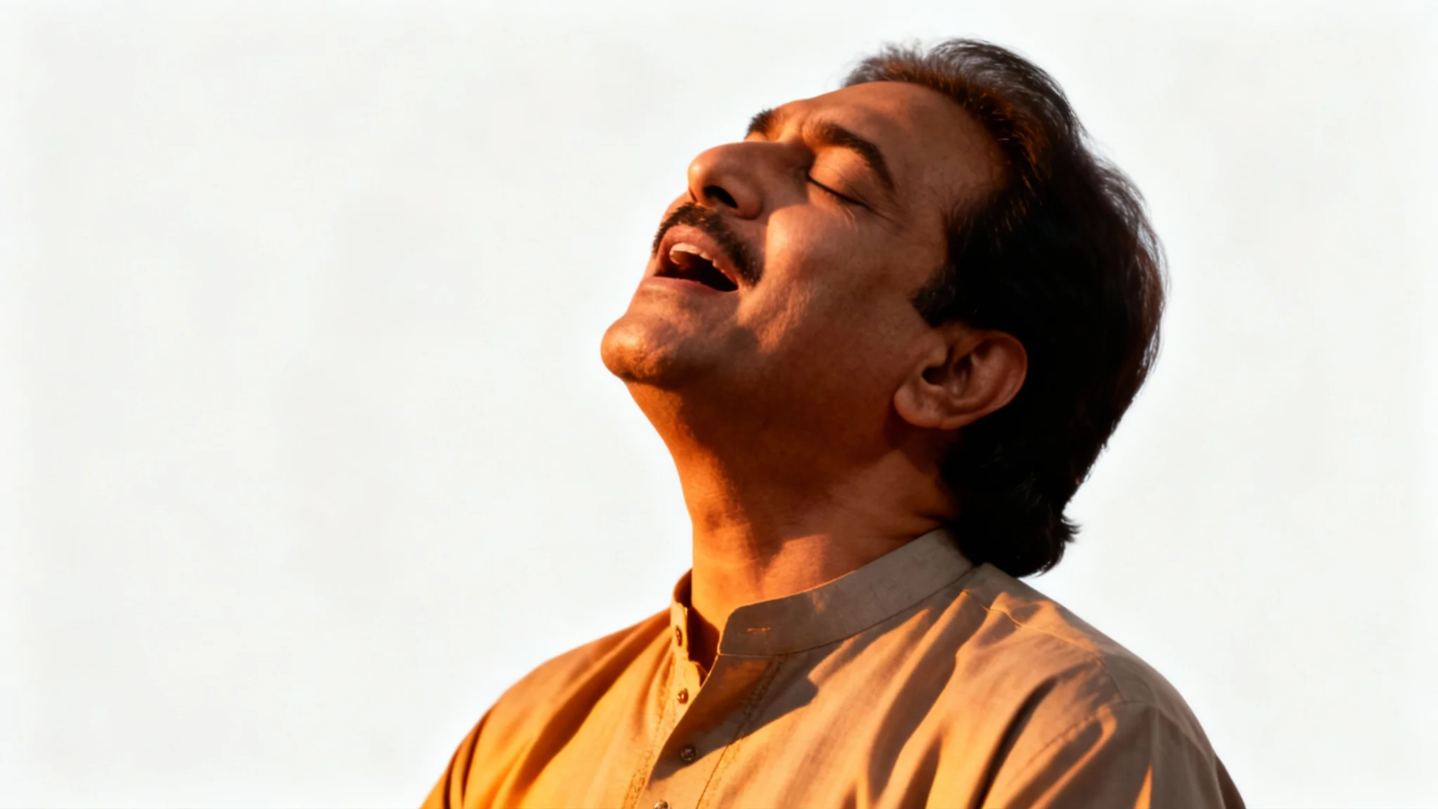 A soulful, black and white style portrait of Nusrat Fateh Ali Khan singing passionately, with his eyes closed, against a plain white background.