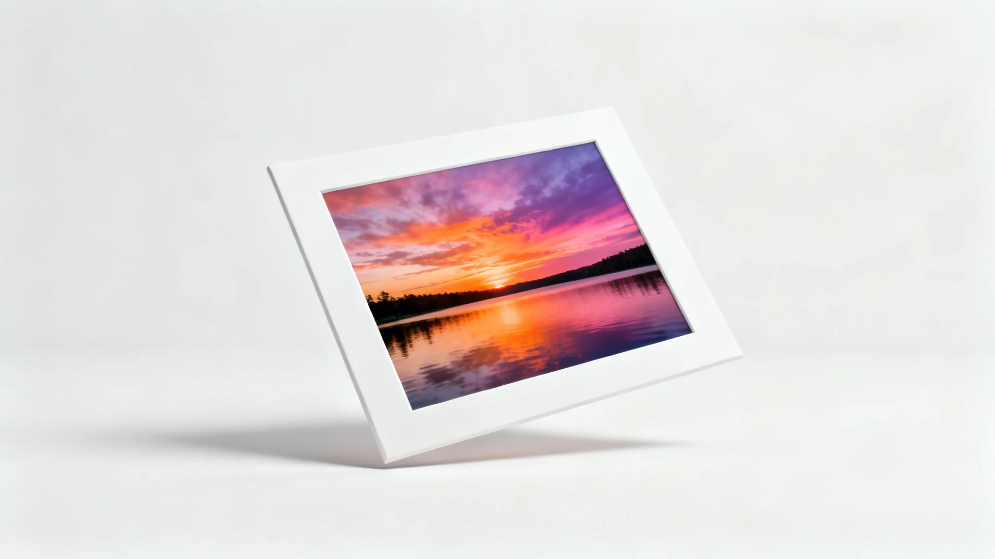 A photorealistic image of a landscape photograph with a thick white border, displayed against a plain white background, illustrating the effect of adding a border to a photo.